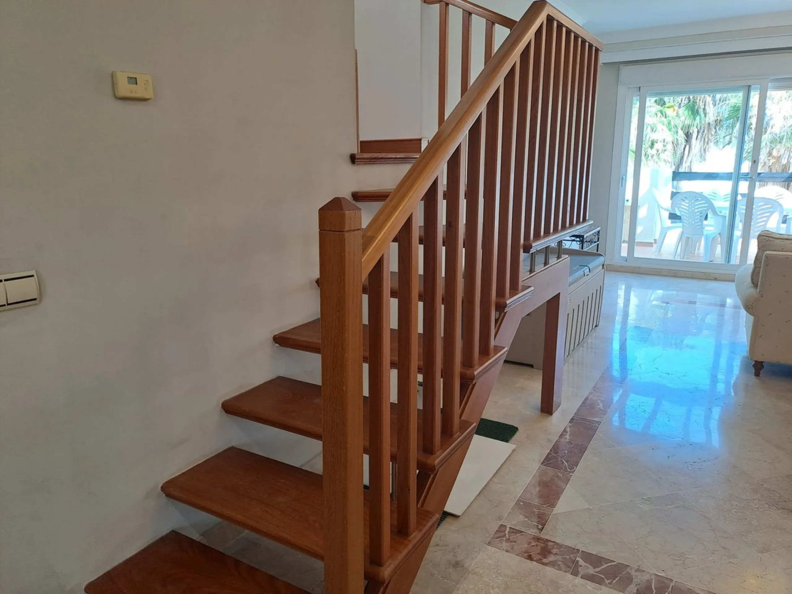 Welcome to this stunning 2-bedroom, 2-bathroom apartment, perfectly situated in a gated community that offers both comfort and convenience. As you step inside, a small hallway leads you to a spacious open-plan living room that connects to a grand solarium