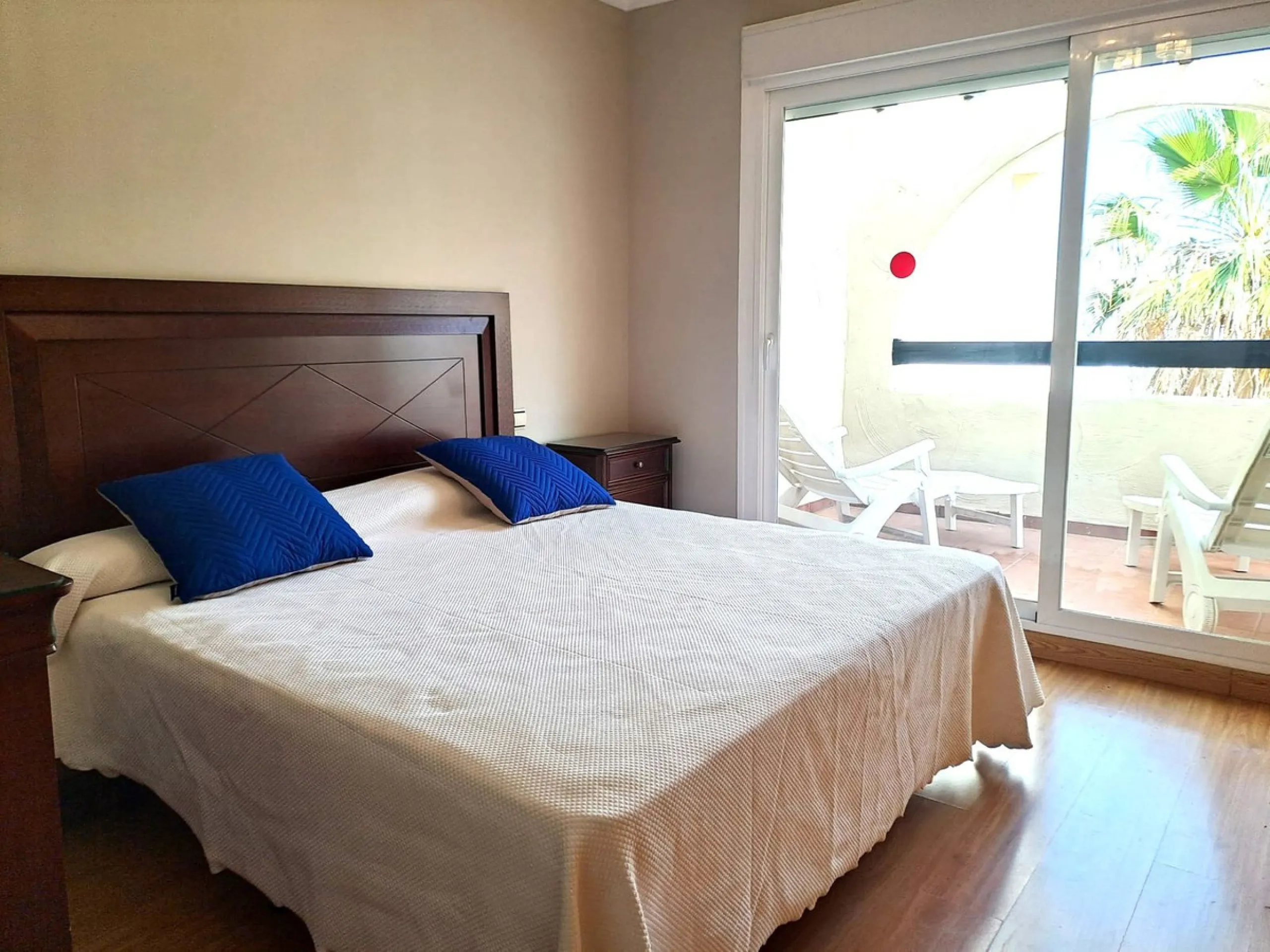 Welcome to this stunning 2-bedroom, 2-bathroom apartment, perfectly situated in a gated community that offers both comfort and convenience. As you step inside, a small hallway leads you to a spacious open-plan living room that connects to a grand solarium