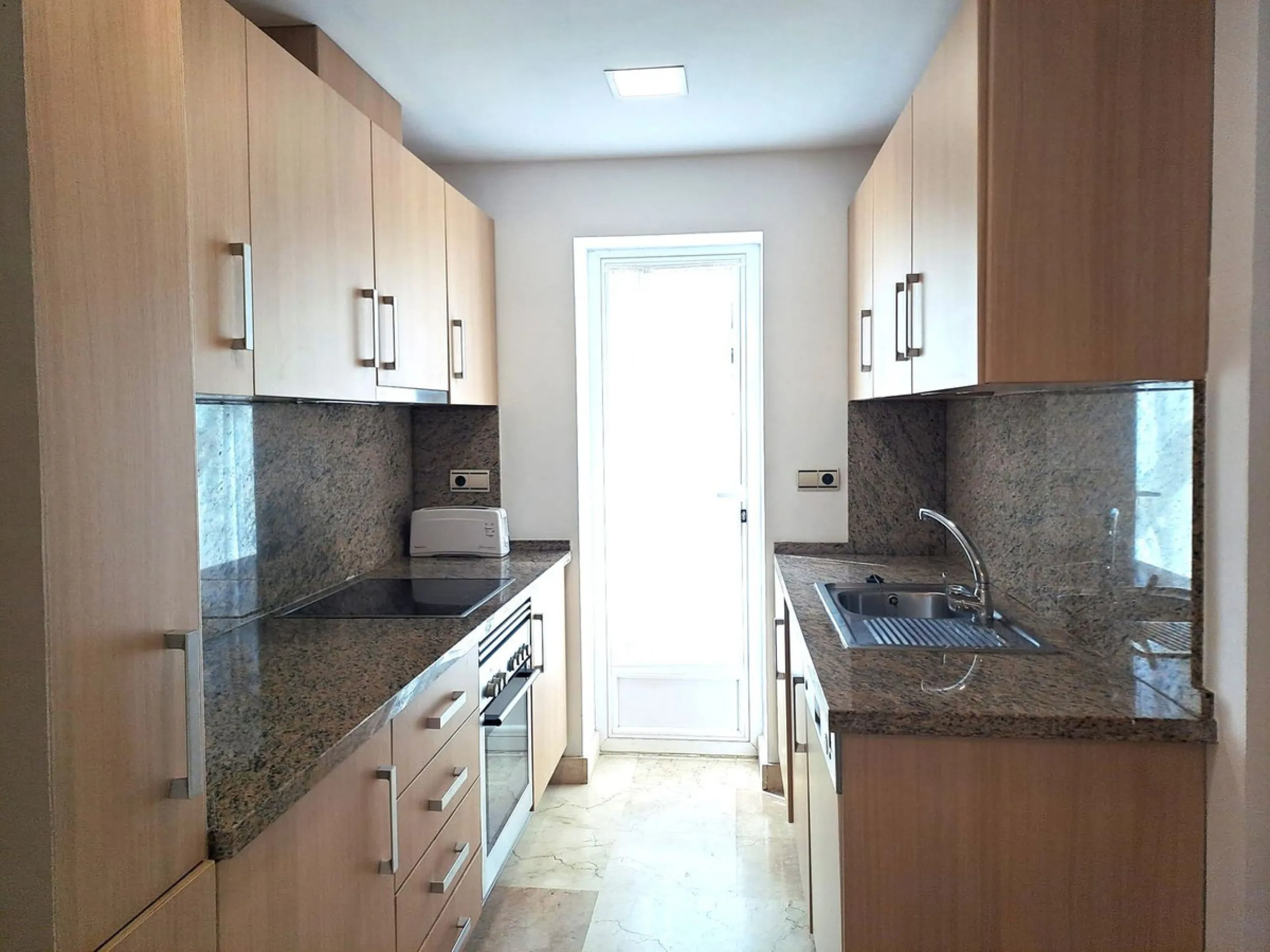 Welcome to this stunning 2-bedroom, 2-bathroom apartment, perfectly situated in a gated community that offers both comfort and convenience. As you step inside, a small hallway leads you to a spacious open-plan living room that connects to a grand solarium