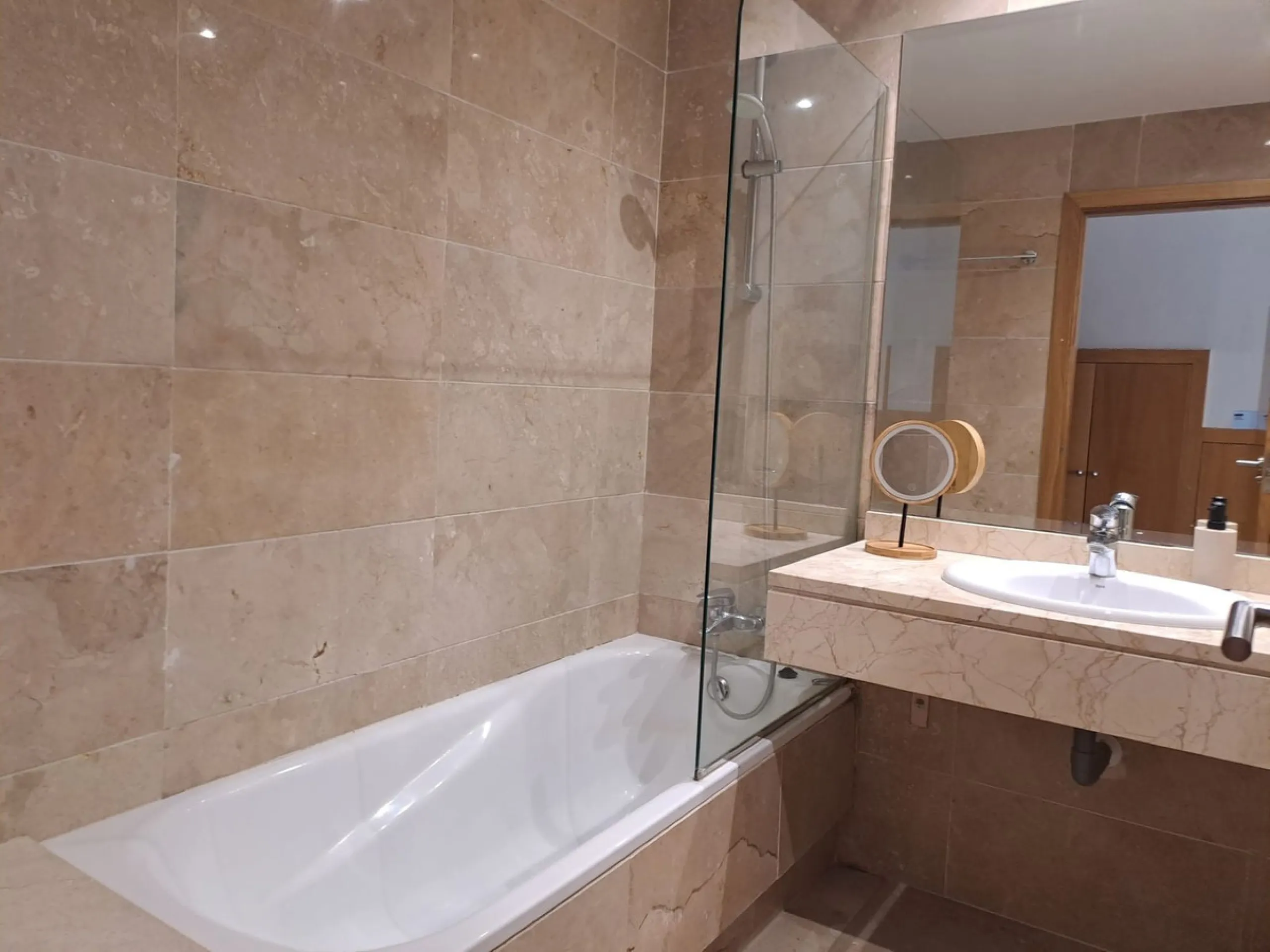 Welcome to this stunning 2-bedroom, 2-bathroom apartment, perfectly situated in a gated community that offers both comfort and convenience. As you step inside, a small hallway leads you to a spacious open-plan living room that connects to a grand solarium
