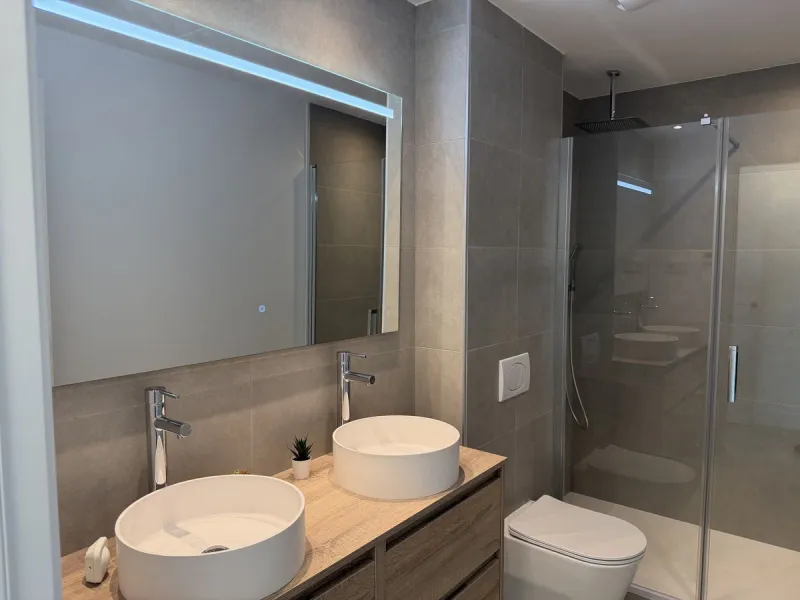 Genießen Sie das Küstenleben in dieser neu gebauten Erdgeschosswohnung mit 120 Quadratmetern im begehrten El Higuerón. Die Wohnung verfügt über zwei großzügige Schlafzimmer und zwei moderne Badezimmer, alles in Top-Qualität ausgeführt und mit ansprechendem Design