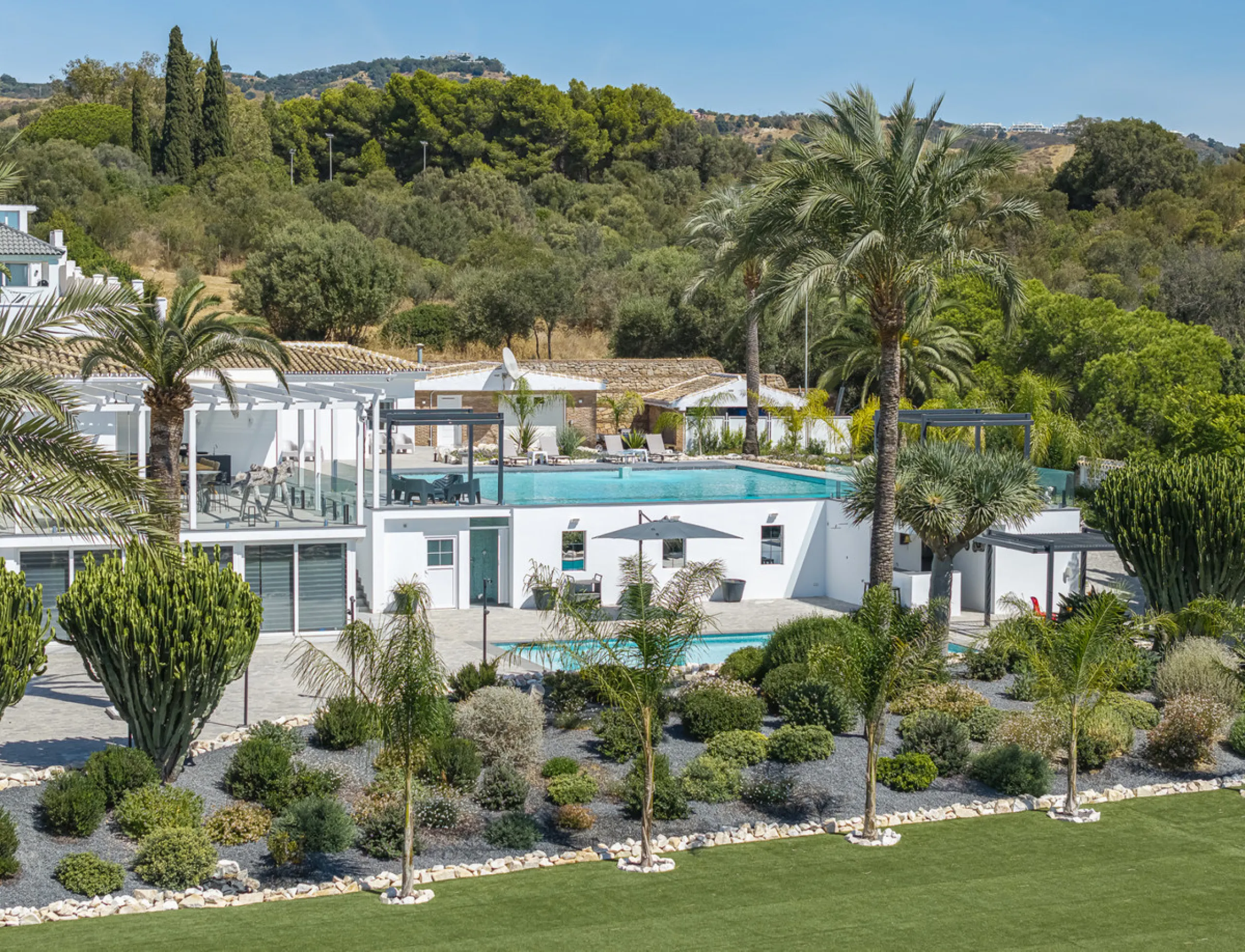 Set on two generous plots totalling 6.128 m², this private and peaceful luxury villa offers a rare blend of modern Mediterranean style and natural beauty in Elviria, Marbella East. Surrounded by its own unspoilt land on one side, the property enjoys excep