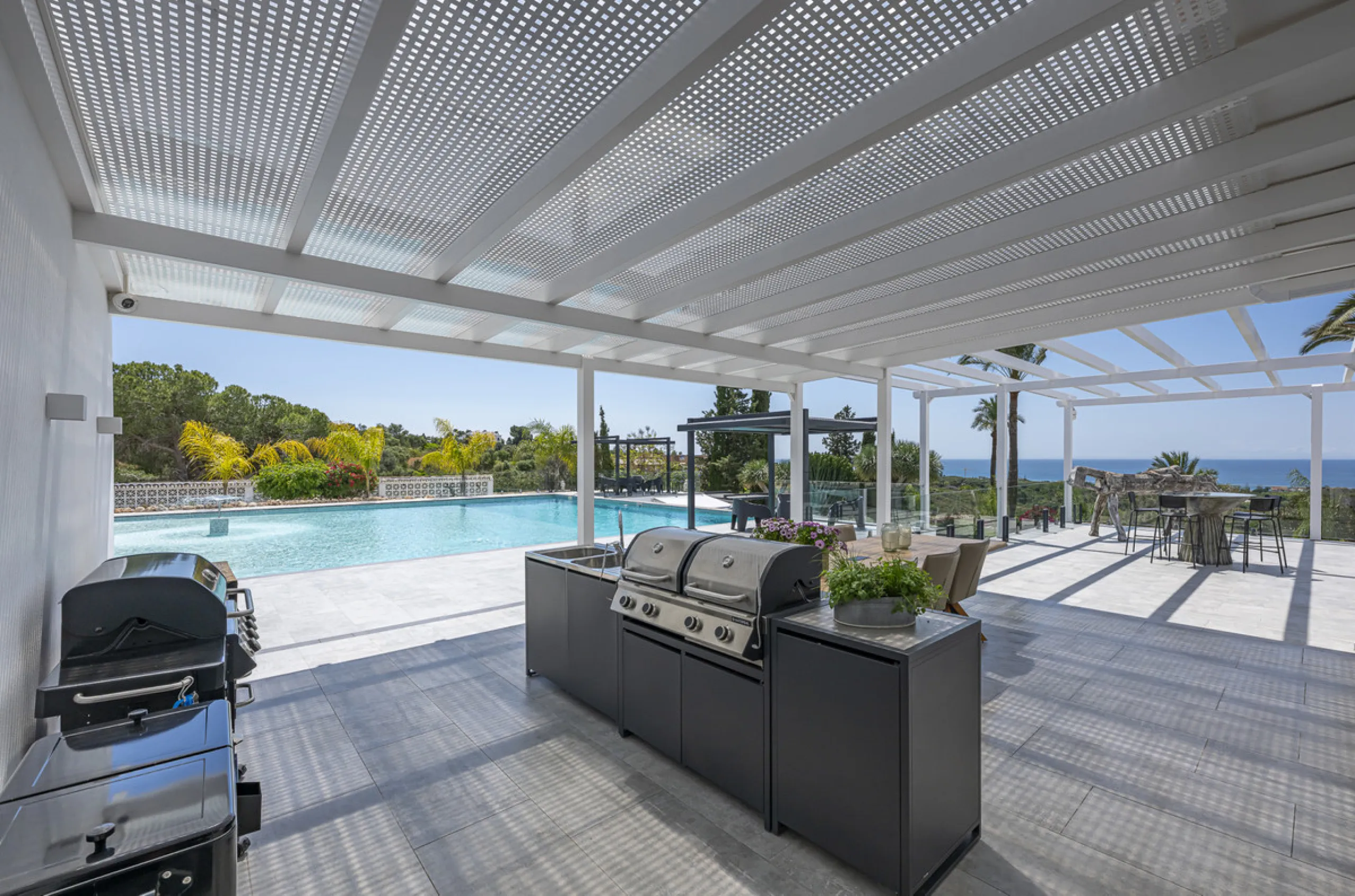 Set on two generous plots totalling 6.128 m², this private and peaceful luxury villa offers a rare blend of modern Mediterranean style and natural beauty in Elviria, Marbella East. Surrounded by its own unspoilt land on one side, the property enjoys excep