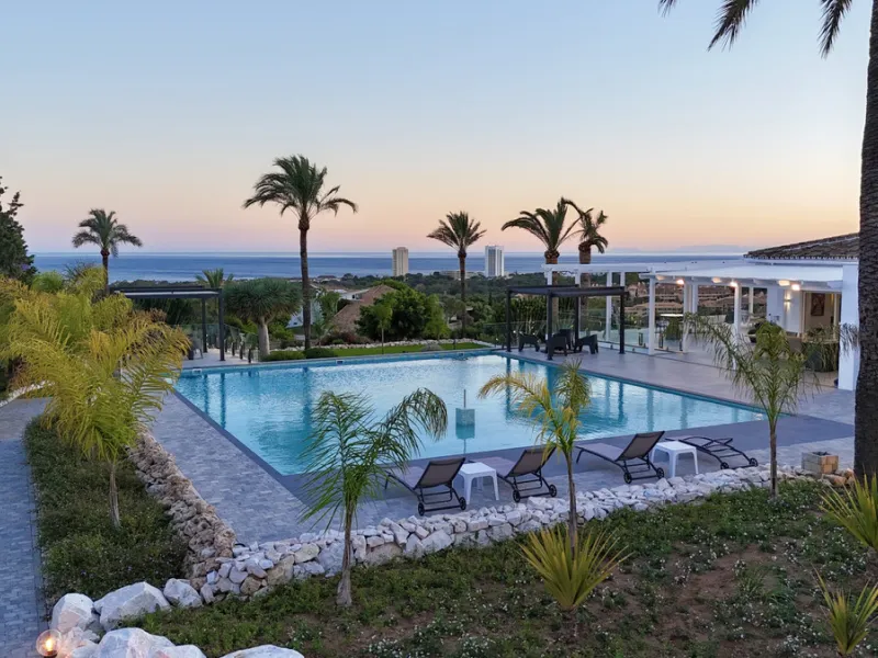 Set on two generous plots totalling 6.128 m², this private and peaceful luxury villa offers a rare blend of modern Mediterranean style and natural beauty in Elviria, Marbella East. Surrounded by its own unspoilt land on one side, the property enjoys excep