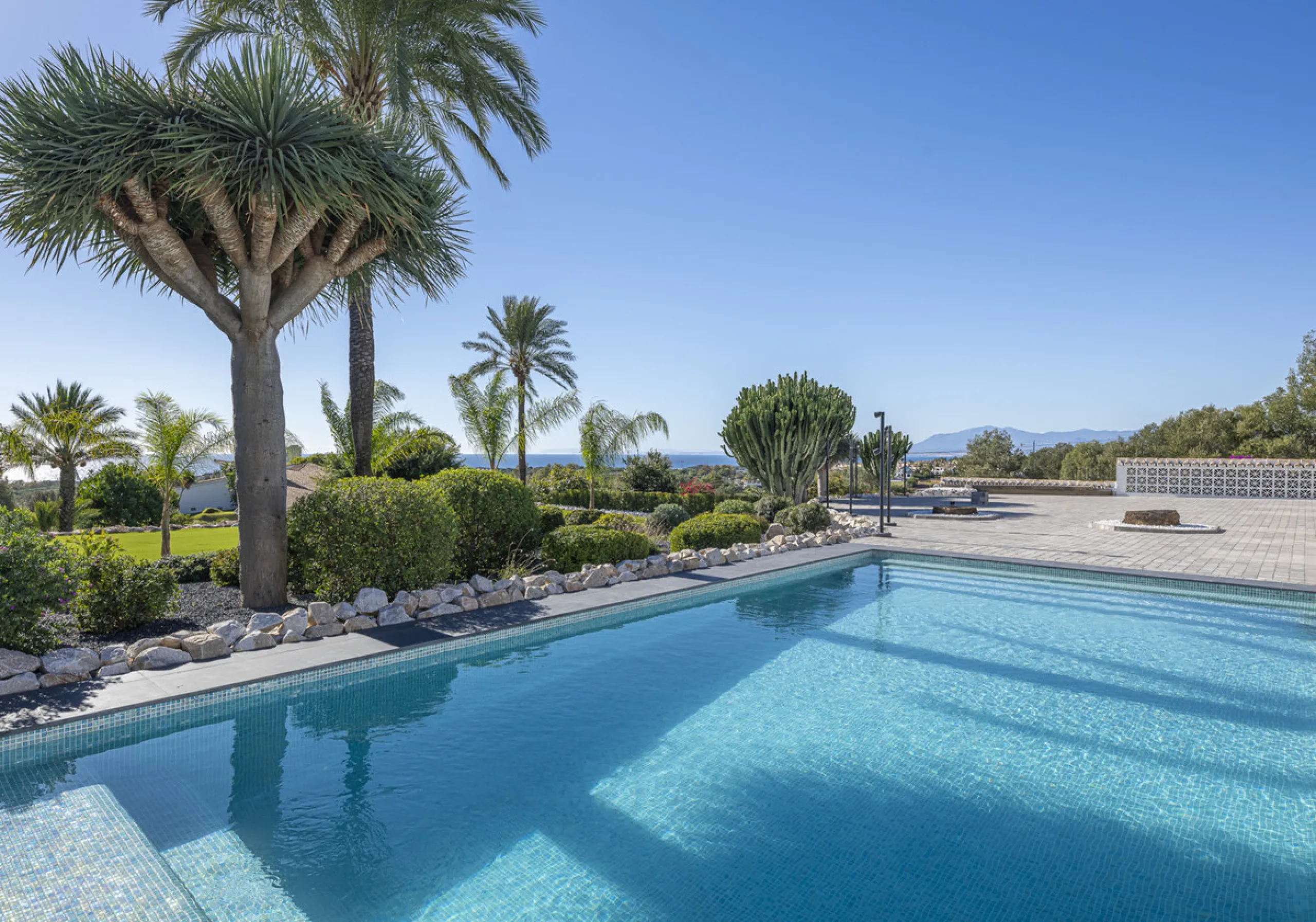 Set on two generous plots totalling 6.128 m², this private and peaceful luxury villa offers a rare blend of modern Mediterranean style and natural beauty in Elviria, Marbella East. Surrounded by its own unspoilt land on one side, the property enjoys excep