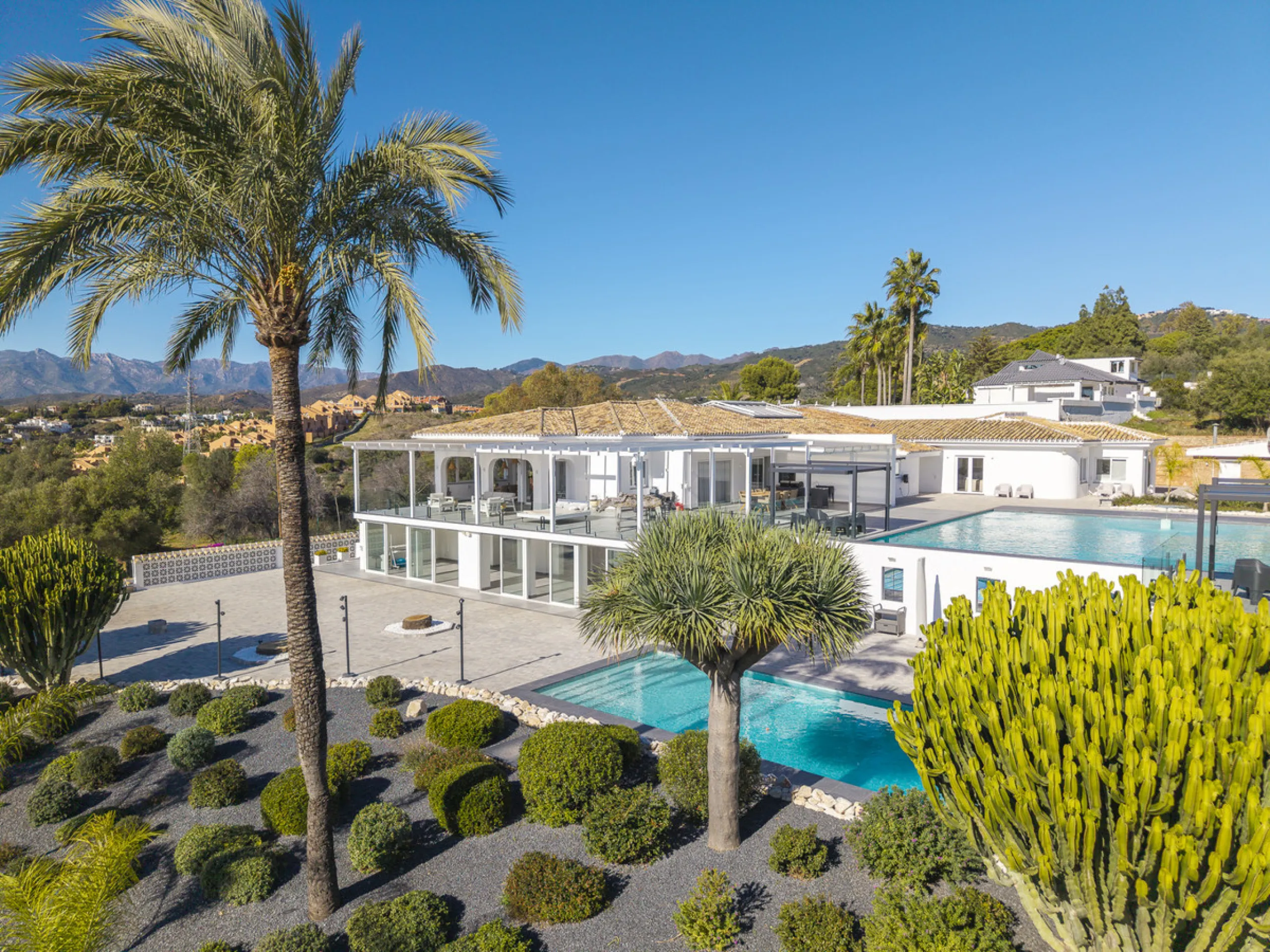 Set on two generous plots totalling 6.128 m², this private and peaceful luxury villa offers a rare blend of modern Mediterranean style and natural beauty in Elviria, Marbella East. Surrounded by its own unspoilt land on one side, the property enjoys excep