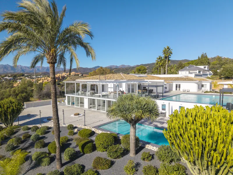 Set on two generous plots totalling 6.128 m², this private and peaceful luxury villa offers a rare blend of modern Mediterranean style and natural beauty in Elviria, Marbella East. Surrounded by its own unspoilt land on one side, the property enjoys excep