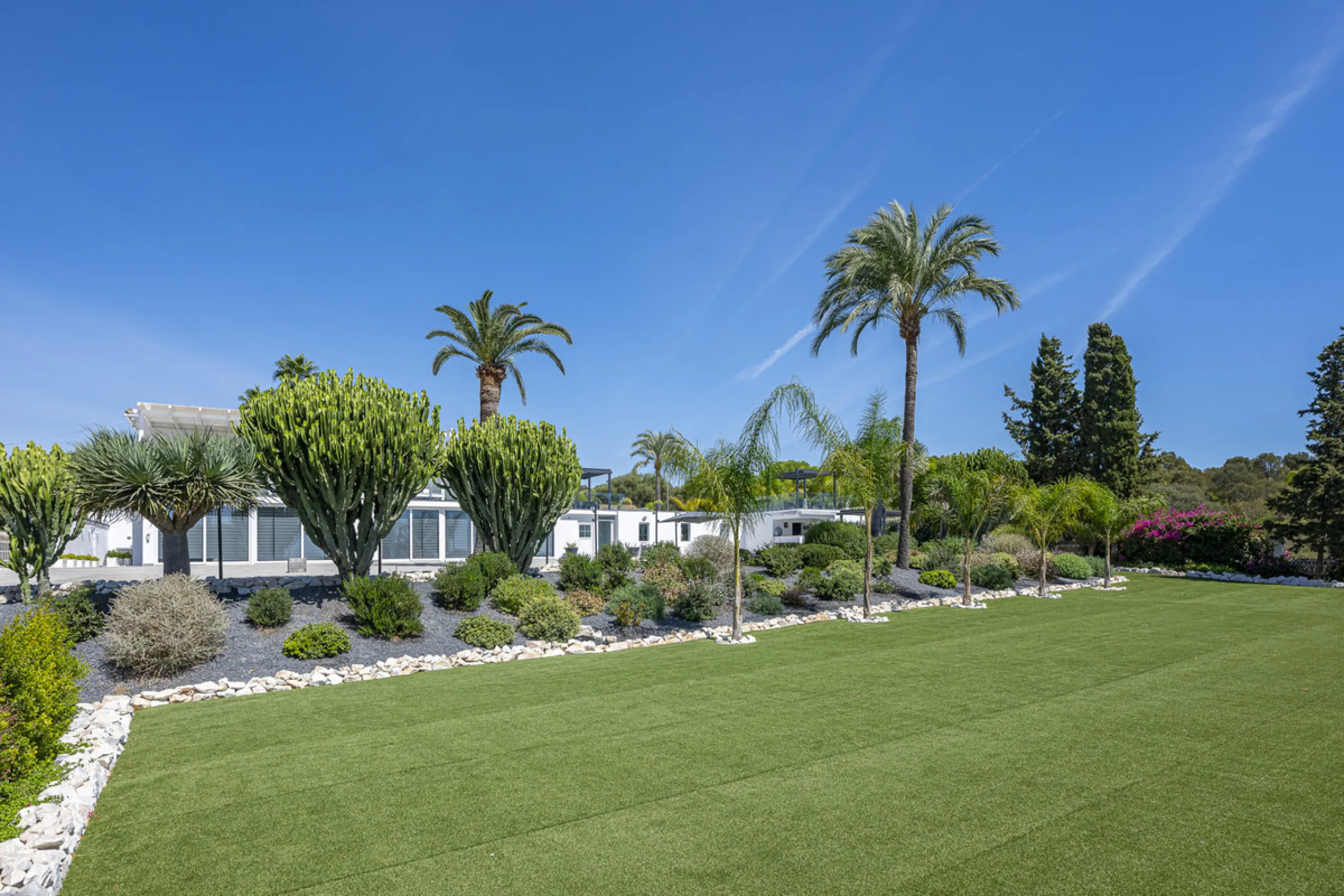 Set on two generous plots totalling 6.128 m², this private and peaceful luxury villa offers a rare blend of modern Mediterranean style and natural beauty in Elviria, Marbella East. Surrounded by its own unspoilt land on one side, the property enjoys excep