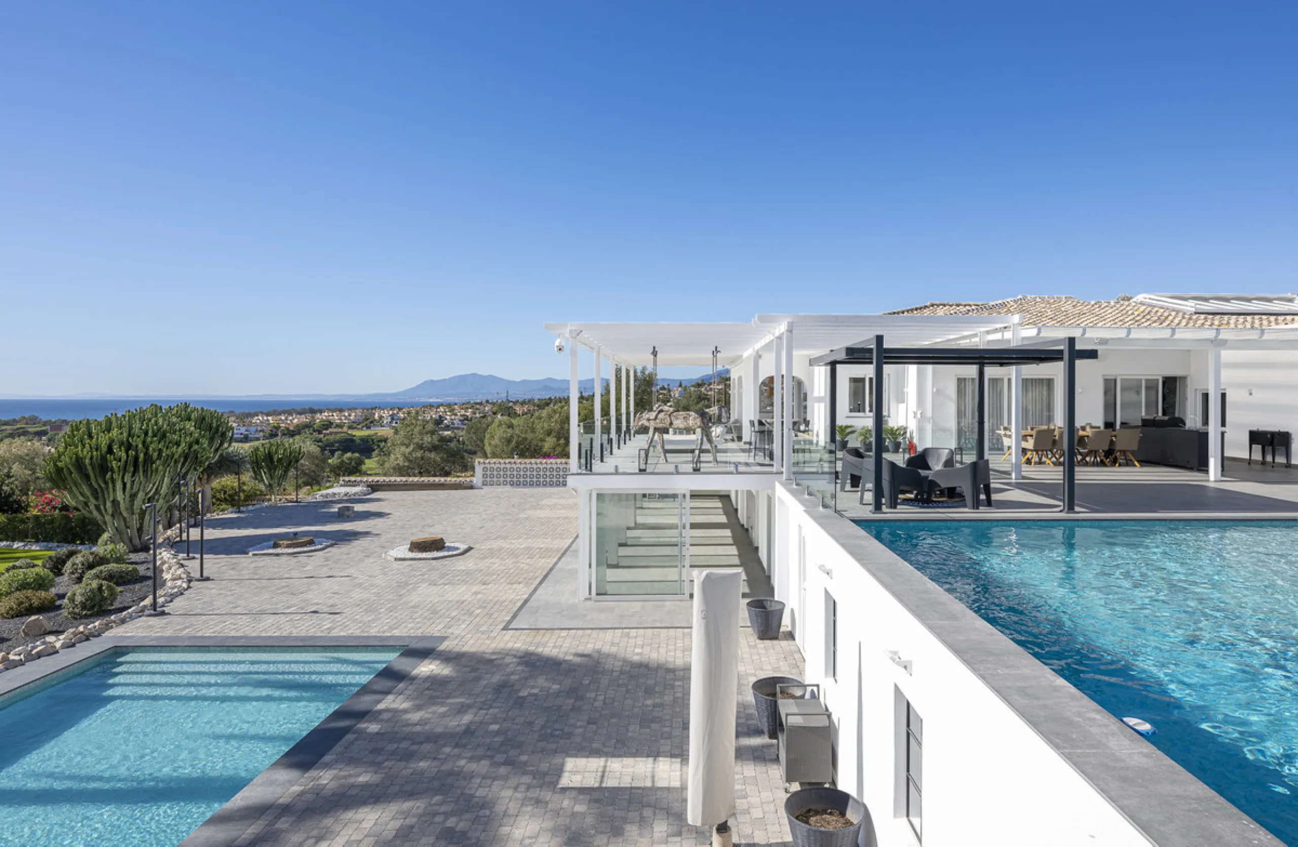 Set on two generous plots totalling 6.128 m², this private and peaceful luxury villa offers a rare blend of modern Mediterranean style and natural beauty in Elviria, Marbella East. Surrounded by its own unspoilt land on one side, the property enjoys excep