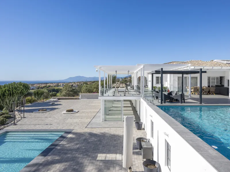 Set on two generous plots totalling 6.128 m², this private and peaceful luxury villa offers a rare blend of modern Mediterranean style and natural beauty in Elviria, Marbella East. Surrounded by its own unspoilt land on one side, the property enjoys excep