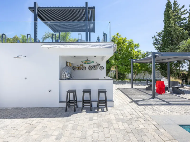 Set on two generous plots totalling 6.128 m², this private and peaceful luxury villa offers a rare blend of modern Mediterranean style and natural beauty in Elviria, Marbella East. Surrounded by its own unspoilt land on one side, the property enjoys excep