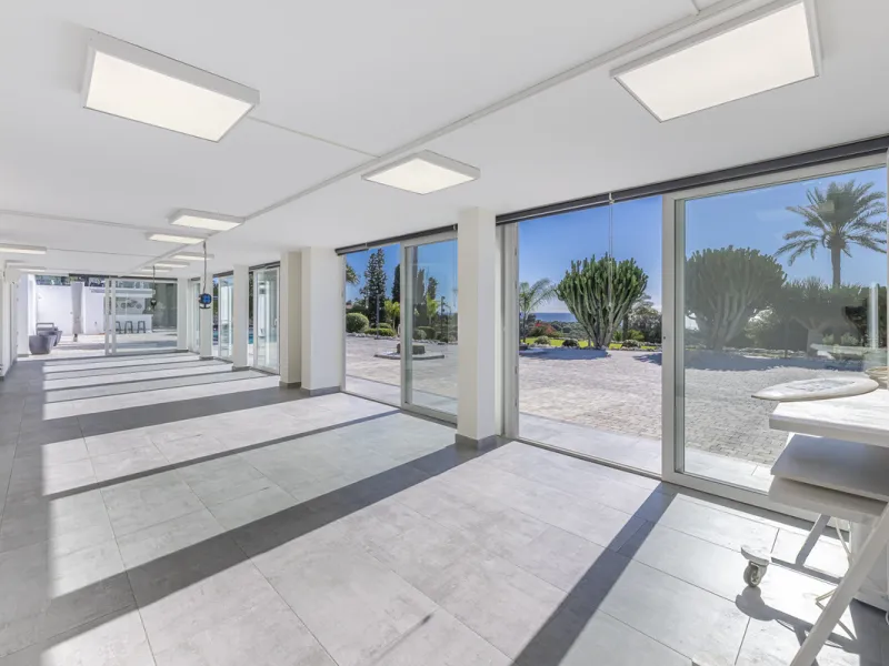 Set on two generous plots totalling 6.128 m², this private and peaceful luxury villa offers a rare blend of modern Mediterranean style and natural beauty in Elviria, Marbella East. Surrounded by its own unspoilt land on one side, the property enjoys excep