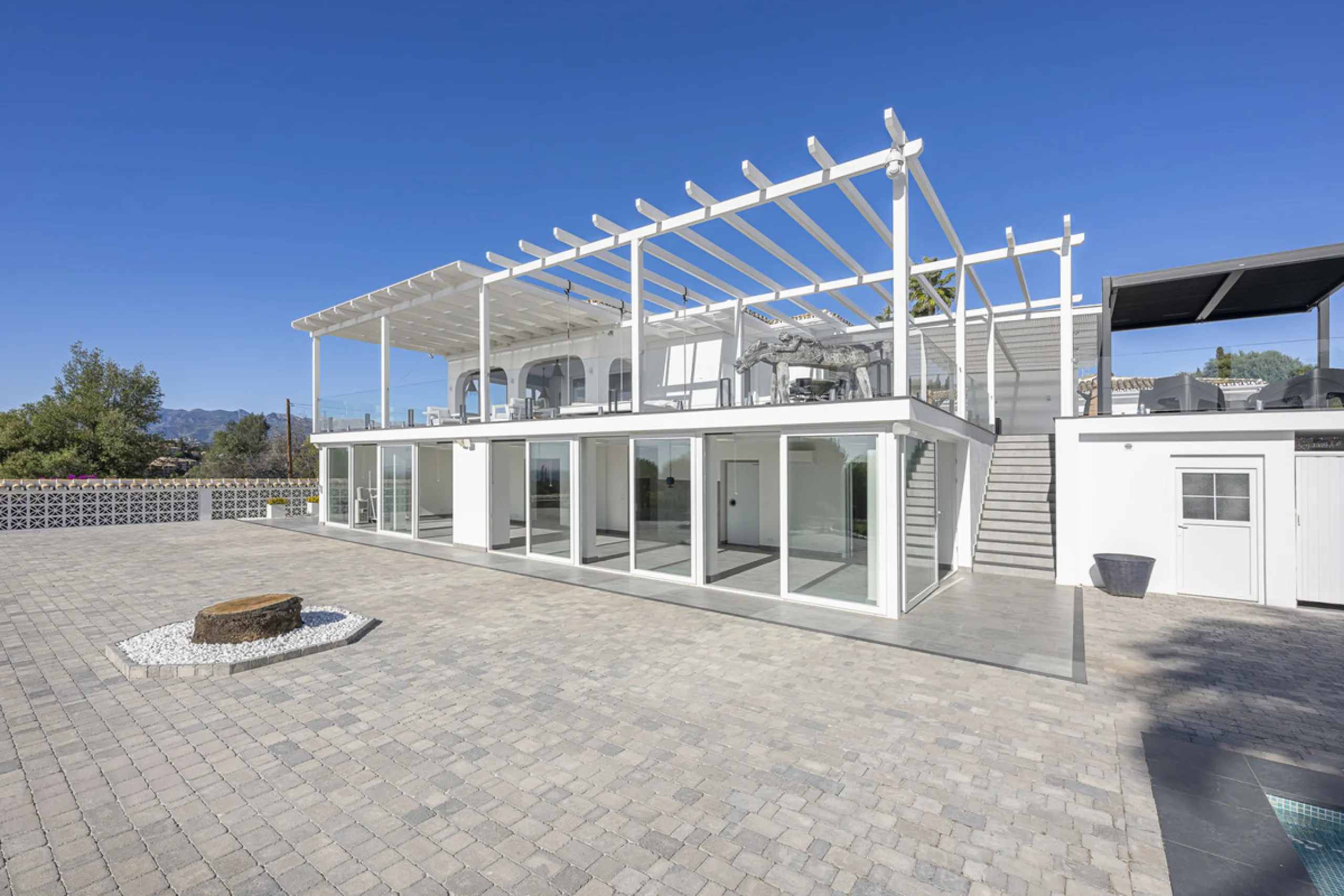 Set on two generous plots totalling 6.128 m², this private and peaceful luxury villa offers a rare blend of modern Mediterranean style and natural beauty in Elviria, Marbella East. Surrounded by its own unspoilt land on one side, the property enjoys excep