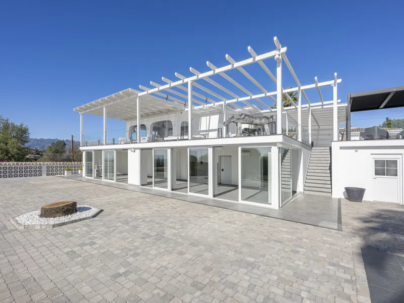 Set on two generous plots totalling 6.128 m², this private and peaceful luxury villa offers a rare blend of modern Mediterranean style and natural beauty in Elviria, Marbella East. Surrounded by its own unspoilt land on one side, the property enjoys excep