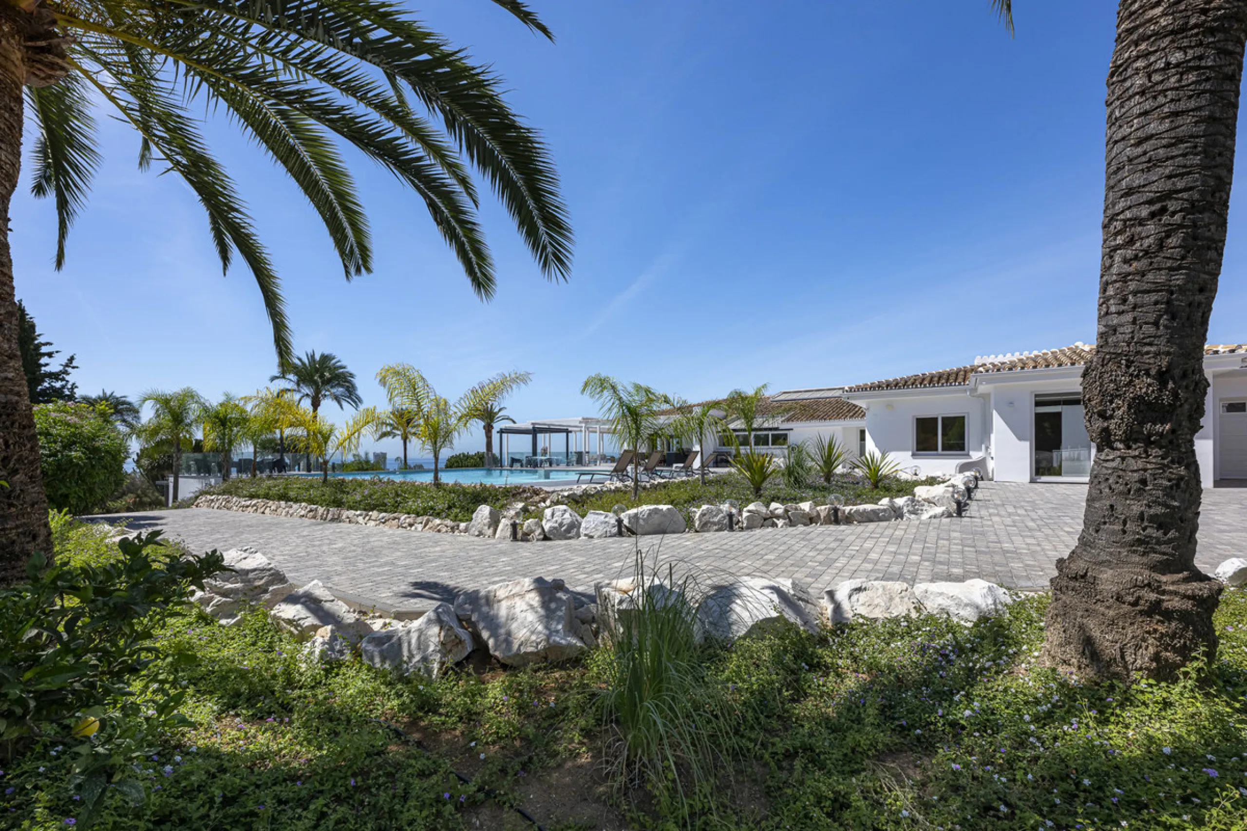 Set on two generous plots totalling 6.128 m², this private and peaceful luxury villa offers a rare blend of modern Mediterranean style and natural beauty in Elviria, Marbella East. Surrounded by its own unspoilt land on one side, the property enjoys excep