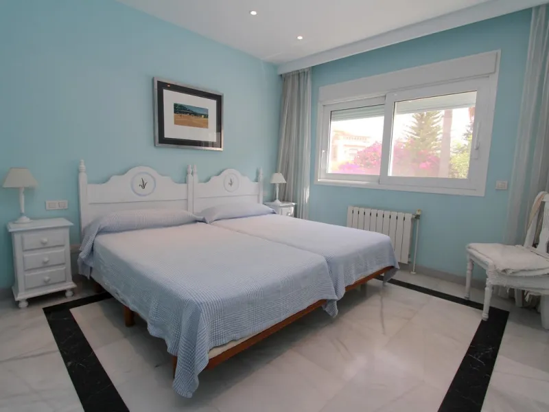 Spacious beachside villa in popular San Pedro, a short drive west of Marbella and Puerto Banús, and within walking distance of the beach promenade, shops and restaurants. This house is set in manicured gardens with a swimming pool, offering a perfect comb