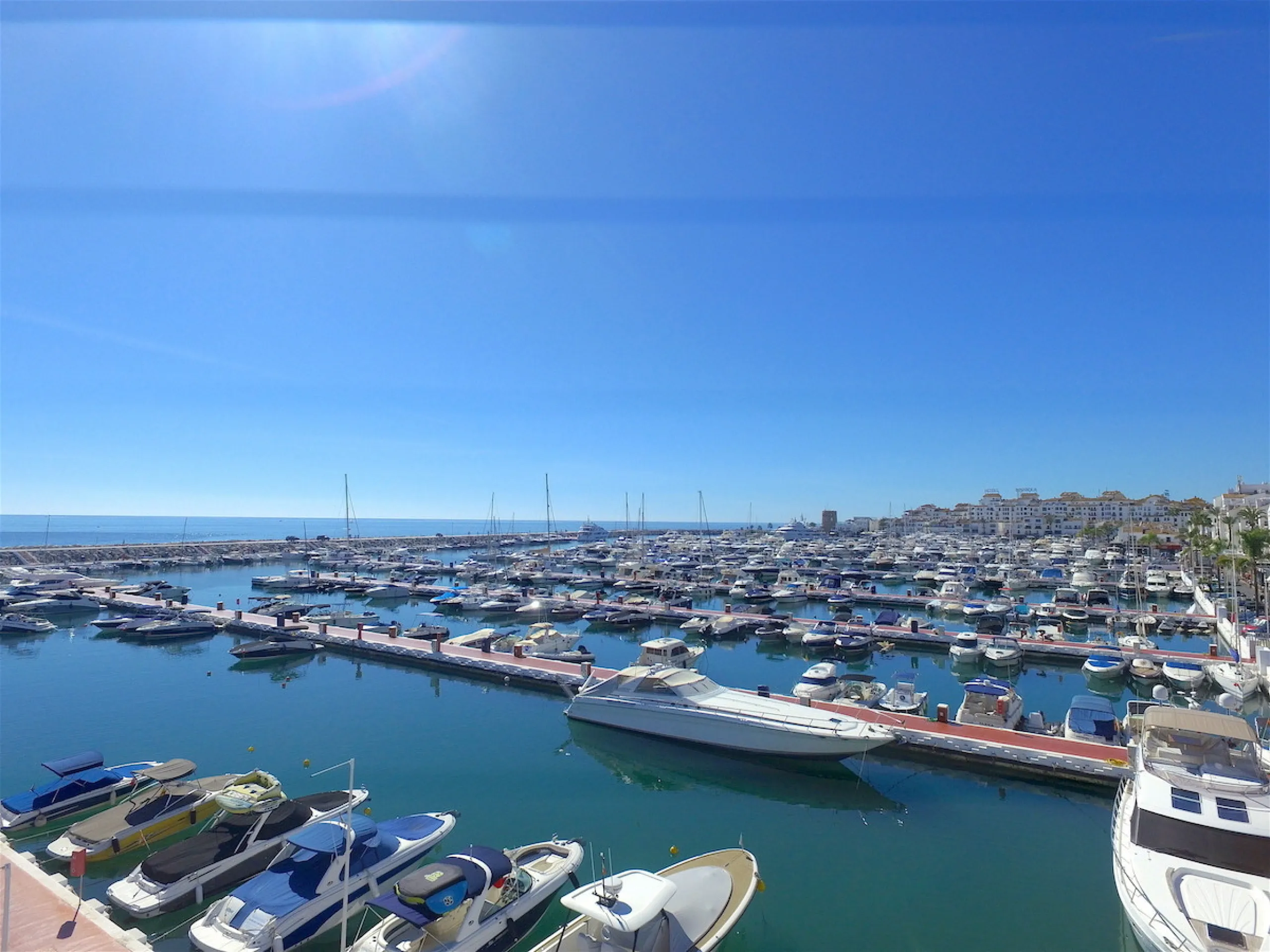 This is a simply beautiful apartment in the fashionable Marina of Puerto Banus with views over the harbour. Completely reformed to a very high standard, it comprises 2 spacious bedrooms, the Master having an ensuite bathroom and another guest bathroom, a 