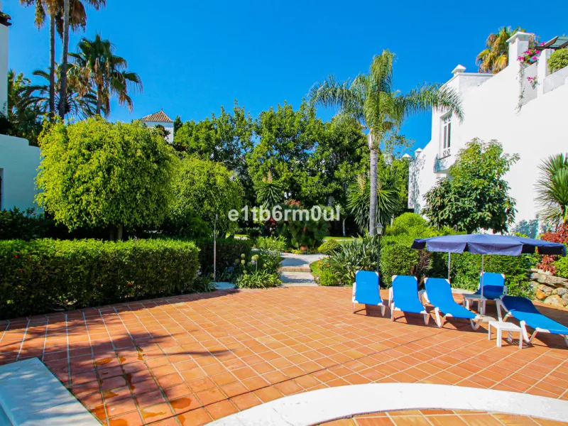 BEACHSIDE • WALKING DISTANCE TO MARBELLA CENTRE & ALL AMENITIES • Cheerful corner ground floor two bedroom apartment just steps from the beach. Located in a very desirable complex with lush mature gardens and swimming pool, right on the promenade, just a 