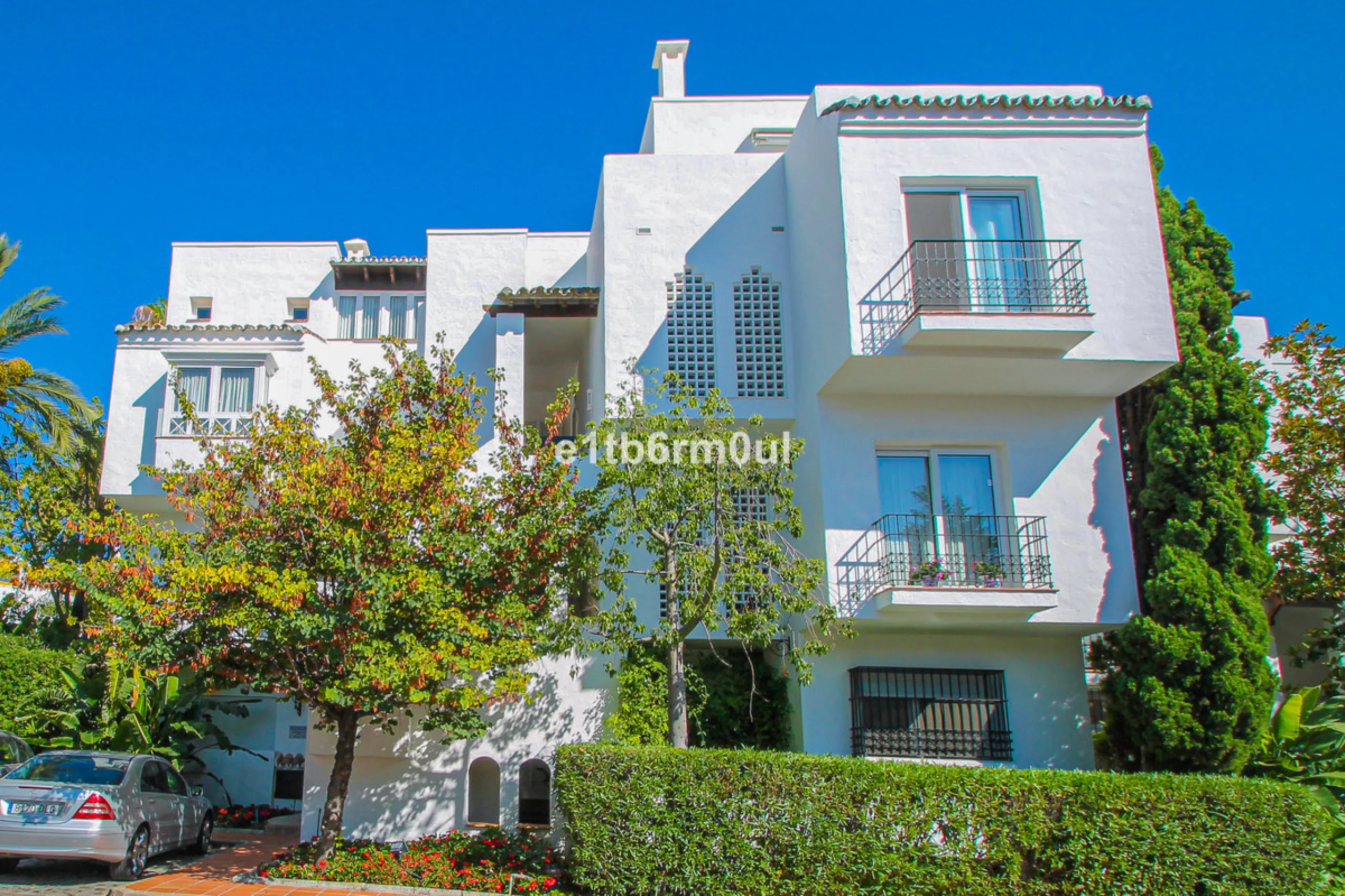 BEACHSIDE • WALKING DISTANCE TO MARBELLA CENTRE & ALL AMENITIES • Cheerful corner ground floor two bedroom apartment just steps from the beach. Located in a very desirable complex with lush mature gardens and swimming pool, right on the promenade, just a 