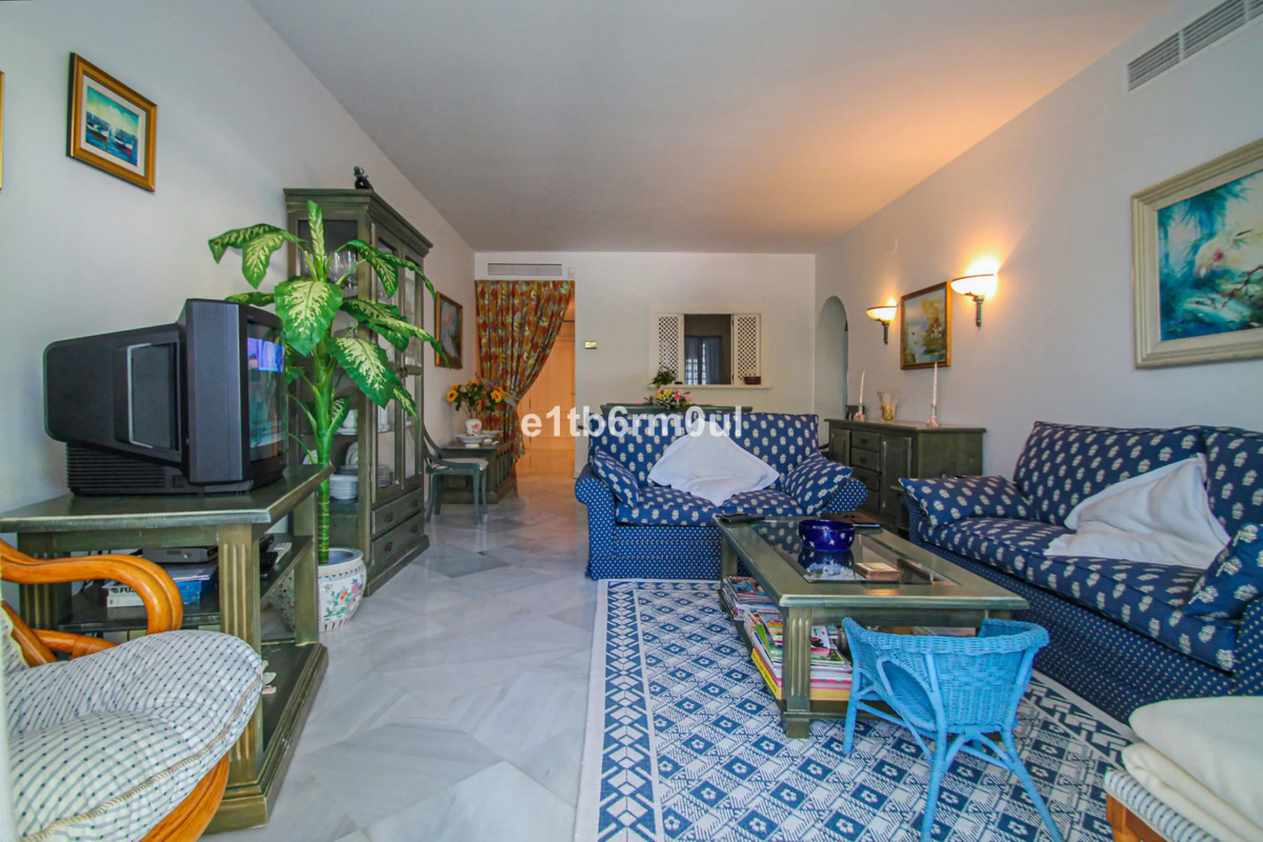 BEACHSIDE • WALKING DISTANCE TO MARBELLA CENTRE & ALL AMENITIES • Cheerful corner ground floor two bedroom apartment just steps from the beach. Located in a very desirable complex with lush mature gardens and swimming pool, right on the promenade, just a 