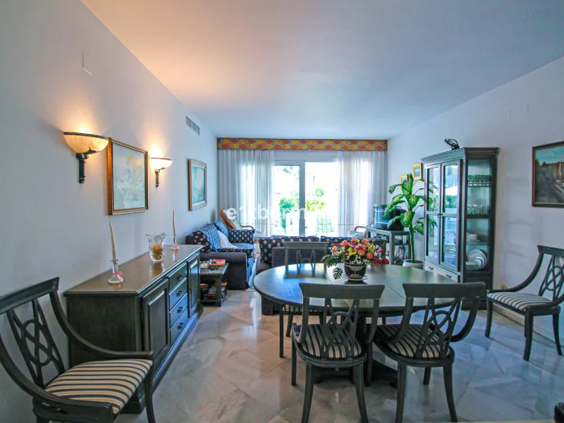 BEACHSIDE • WALKING DISTANCE TO MARBELLA CENTRE & ALL AMENITIES • Cheerful corner ground floor two bedroom apartment just steps from the beach. Located in a very desirable complex with lush mature gardens and swimming pool, right on the promenade, just a 