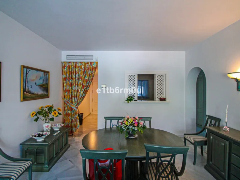 BEACHSIDE • WALKING DISTANCE TO MARBELLA CENTRE & ALL AMENITIES • Cheerful corner ground floor two bedroom apartment just steps from the beach. Located in a very desirable complex with lush mature gardens and swimming pool, right on the promenade, just a 