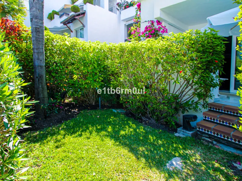 BEACHSIDE • WALKING DISTANCE TO MARBELLA CENTRE & ALL AMENITIES • Cheerful corner ground floor two bedroom apartment just steps from the beach. Located in a very desirable complex with lush mature gardens and swimming pool, right on the promenade, just a 