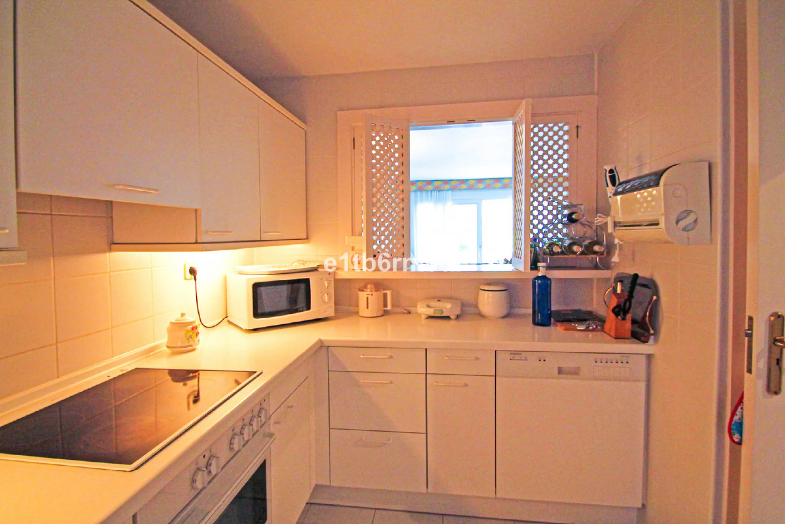 BEACHSIDE • WALKING DISTANCE TO MARBELLA CENTRE & ALL AMENITIES • Cheerful corner ground floor two bedroom apartment just steps from the beach. Located in a very desirable complex with lush mature gardens and swimming pool, right on the promenade, just a 