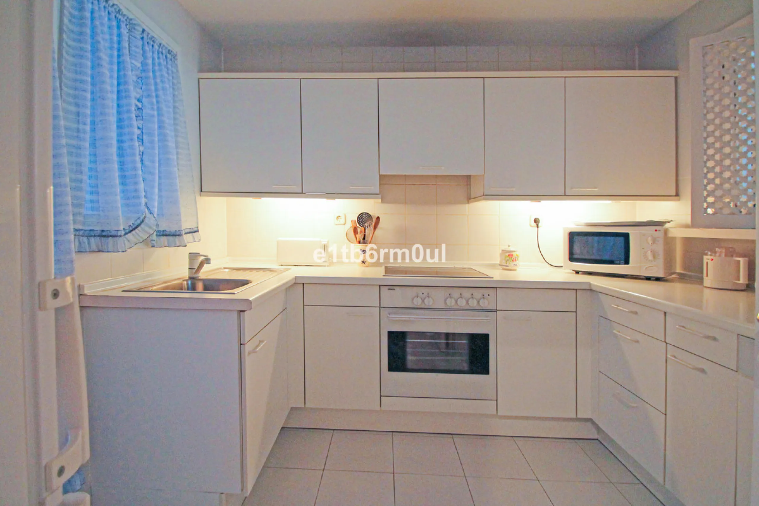 BEACHSIDE • WALKING DISTANCE TO MARBELLA CENTRE & ALL AMENITIES • Cheerful corner ground floor two bedroom apartment just steps from the beach. Located in a very desirable complex with lush mature gardens and swimming pool, right on the promenade, just a 
