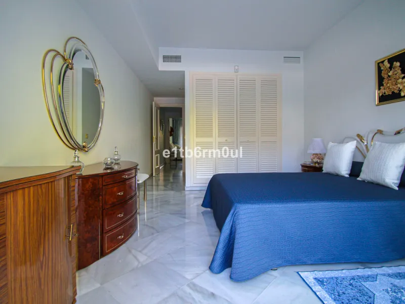 BEACHSIDE • WALKING DISTANCE TO MARBELLA CENTRE & ALL AMENITIES • Cheerful corner ground floor two bedroom apartment just steps from the beach. Located in a very desirable complex with lush mature gardens and swimming pool, right on the promenade, just a 
