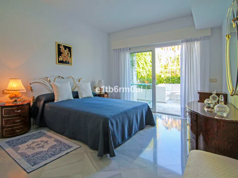 BEACHSIDE • WALKING DISTANCE TO MARBELLA CENTRE & ALL AMENITIES • Cheerful corner ground floor two bedroom apartment just steps from the beach. Located in a very desirable complex with lush mature gardens and swimming pool, right on the promenade, just a 