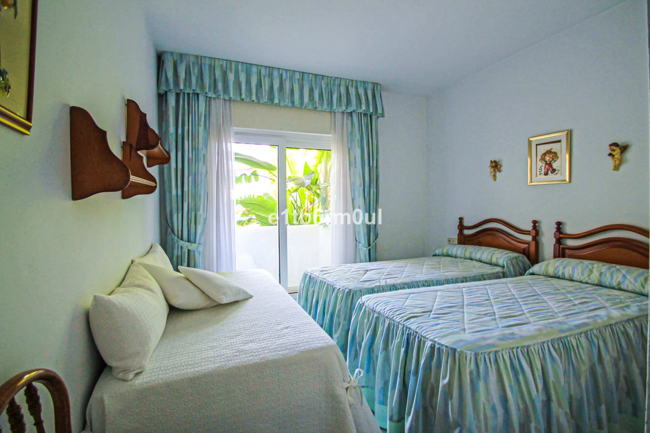 BEACHSIDE • WALKING DISTANCE TO MARBELLA CENTRE & ALL AMENITIES • Cheerful corner ground floor two bedroom apartment just steps from the beach. Located in a very desirable complex with lush mature gardens and swimming pool, right on the promenade, just a 