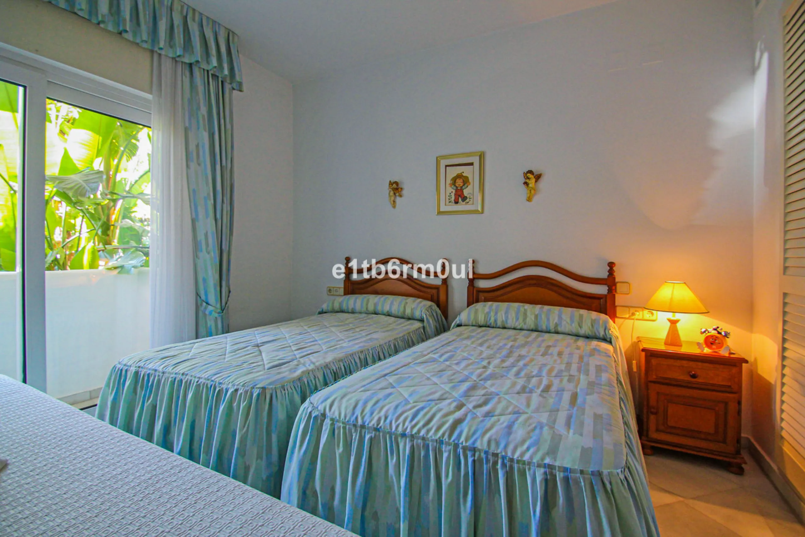 BEACHSIDE • WALKING DISTANCE TO MARBELLA CENTRE & ALL AMENITIES • Cheerful corner ground floor two bedroom apartment just steps from the beach. Located in a very desirable complex with lush mature gardens and swimming pool, right on the promenade, just a 