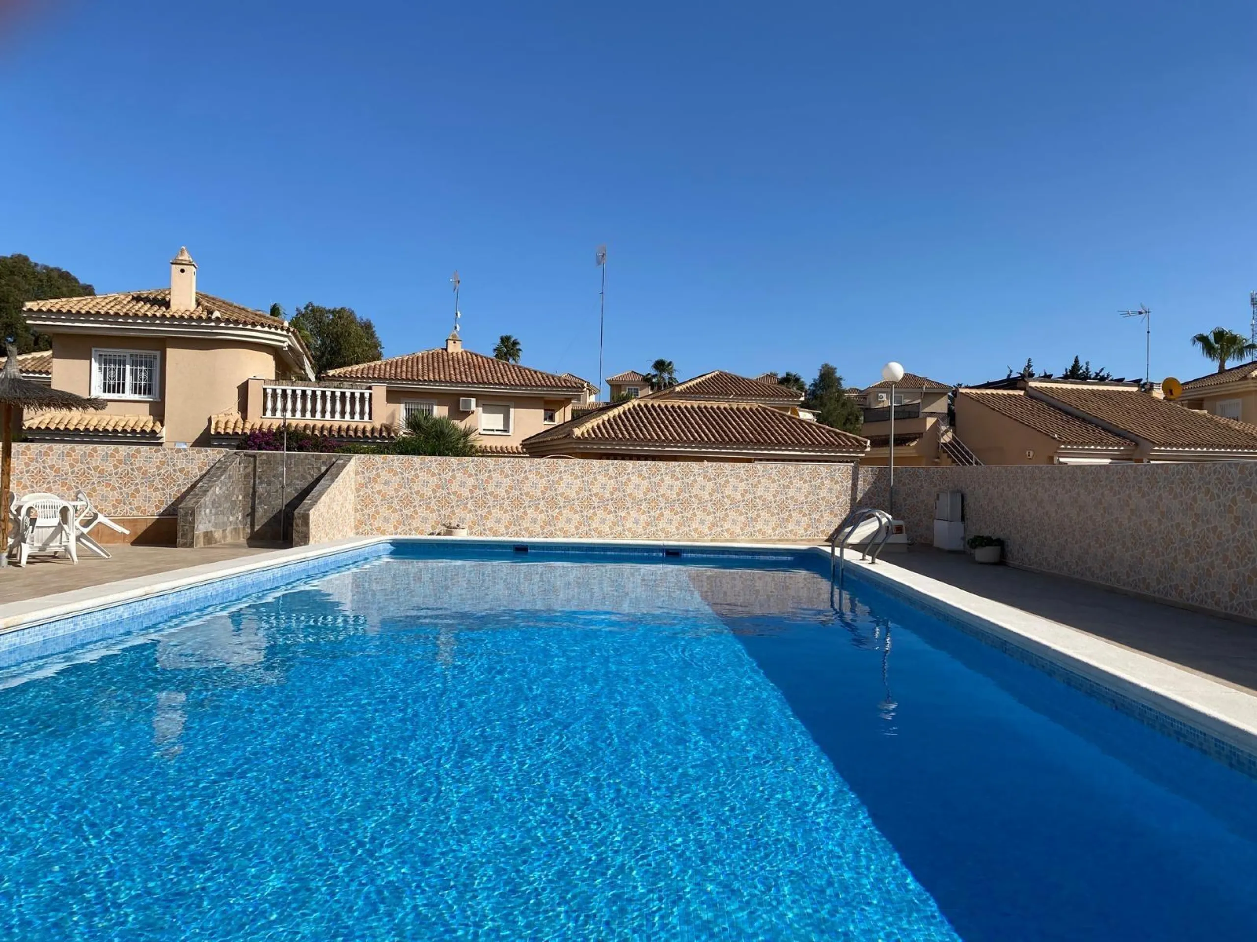 House with large plot, parking, and communal pool