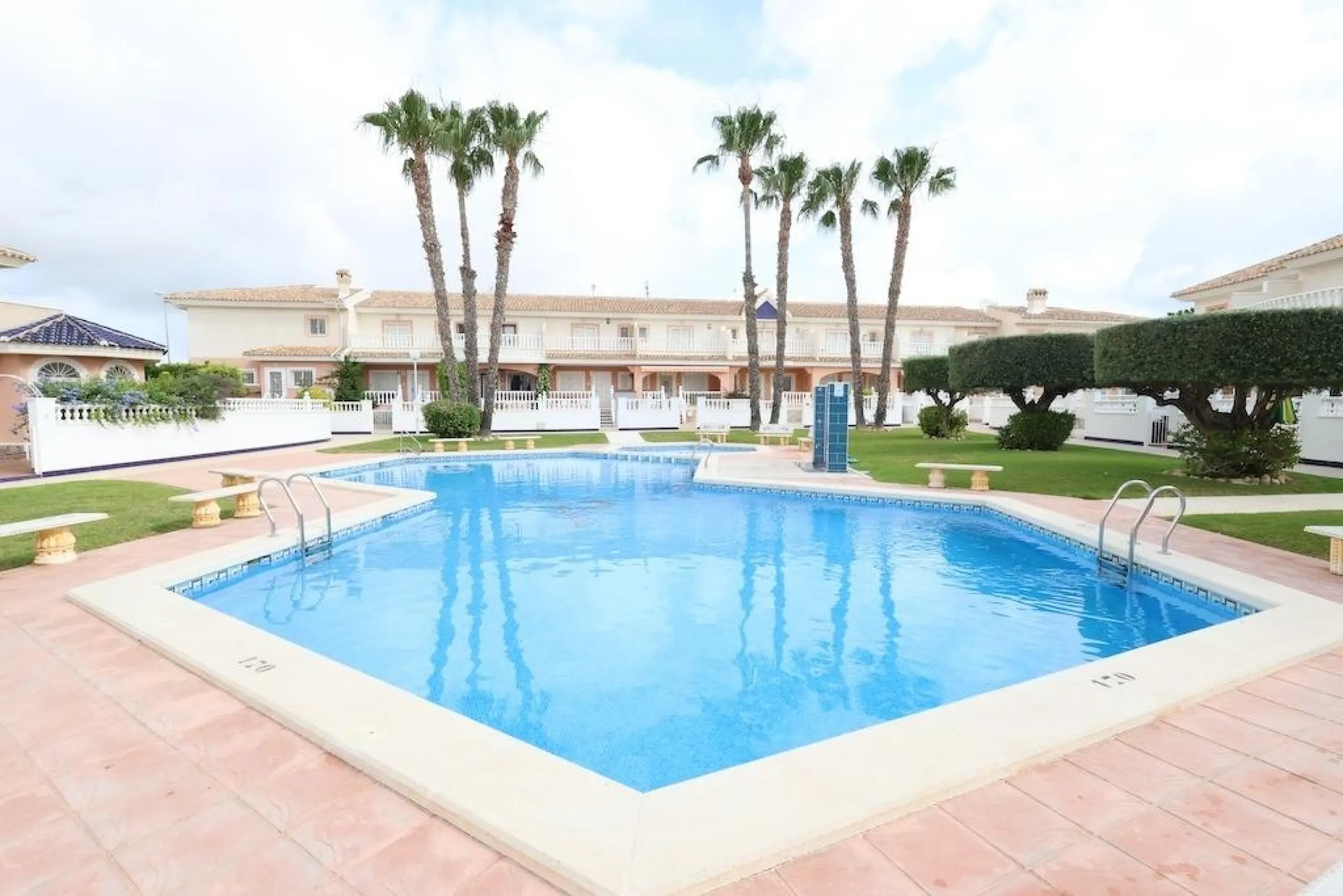Ciudad Quesada, Residencial Elena – Corner townhouse directly facing the communal pool.