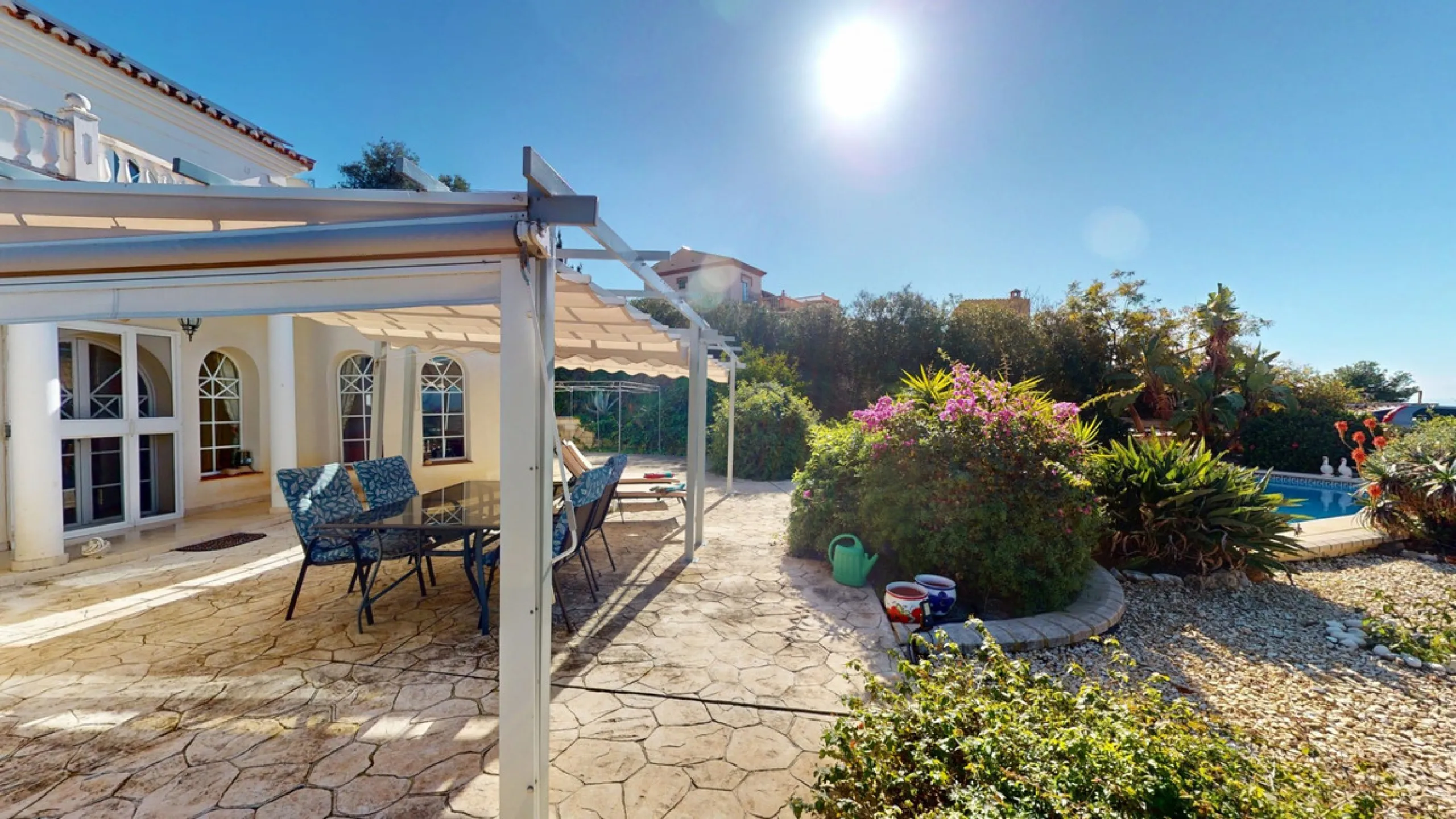 This elegant villa in Arenas, Málaga, offers a harmonious blend of space and style across two levels. The residence boasts four bedrooms and three bathrooms, with the primary bedroom providing generous personal space. The ground floor houses the main livi
