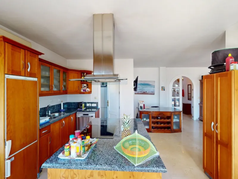 This elegant villa in Arenas, Málaga, offers a harmonious blend of space and style across two levels. The residence boasts four bedrooms and three bathrooms, with the primary bedroom providing generous personal space. The ground floor houses the main livi