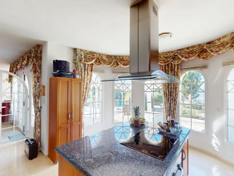 This elegant villa in Arenas, Málaga, offers a harmonious blend of space and style across two levels. The residence boasts four bedrooms and three bathrooms, with the primary bedroom providing generous personal space. The ground floor houses the main livi