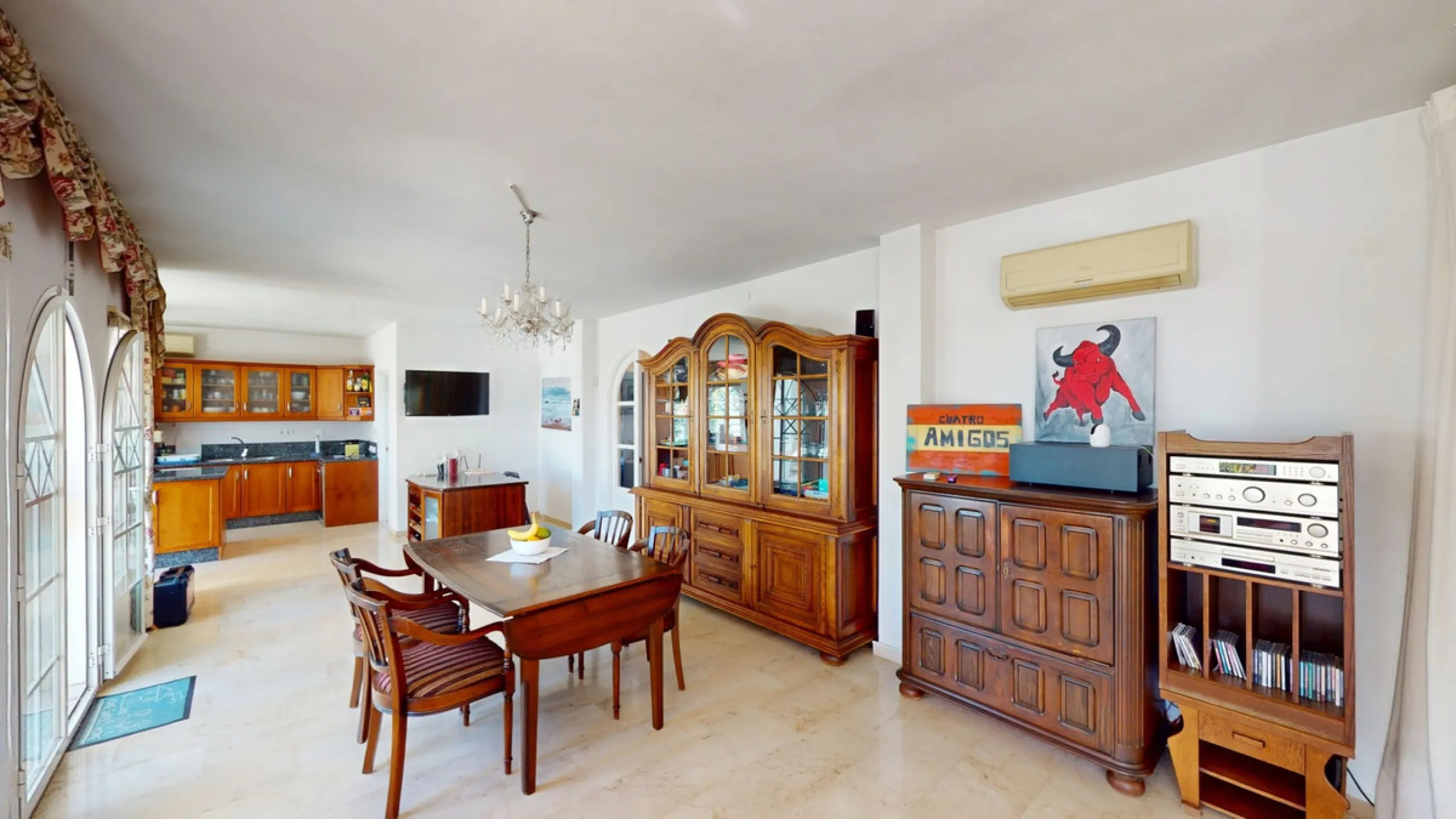 This elegant villa in Arenas, Málaga, offers a harmonious blend of space and style across two levels. The residence boasts four bedrooms and three bathrooms, with the primary bedroom providing generous personal space. The ground floor houses the main livi