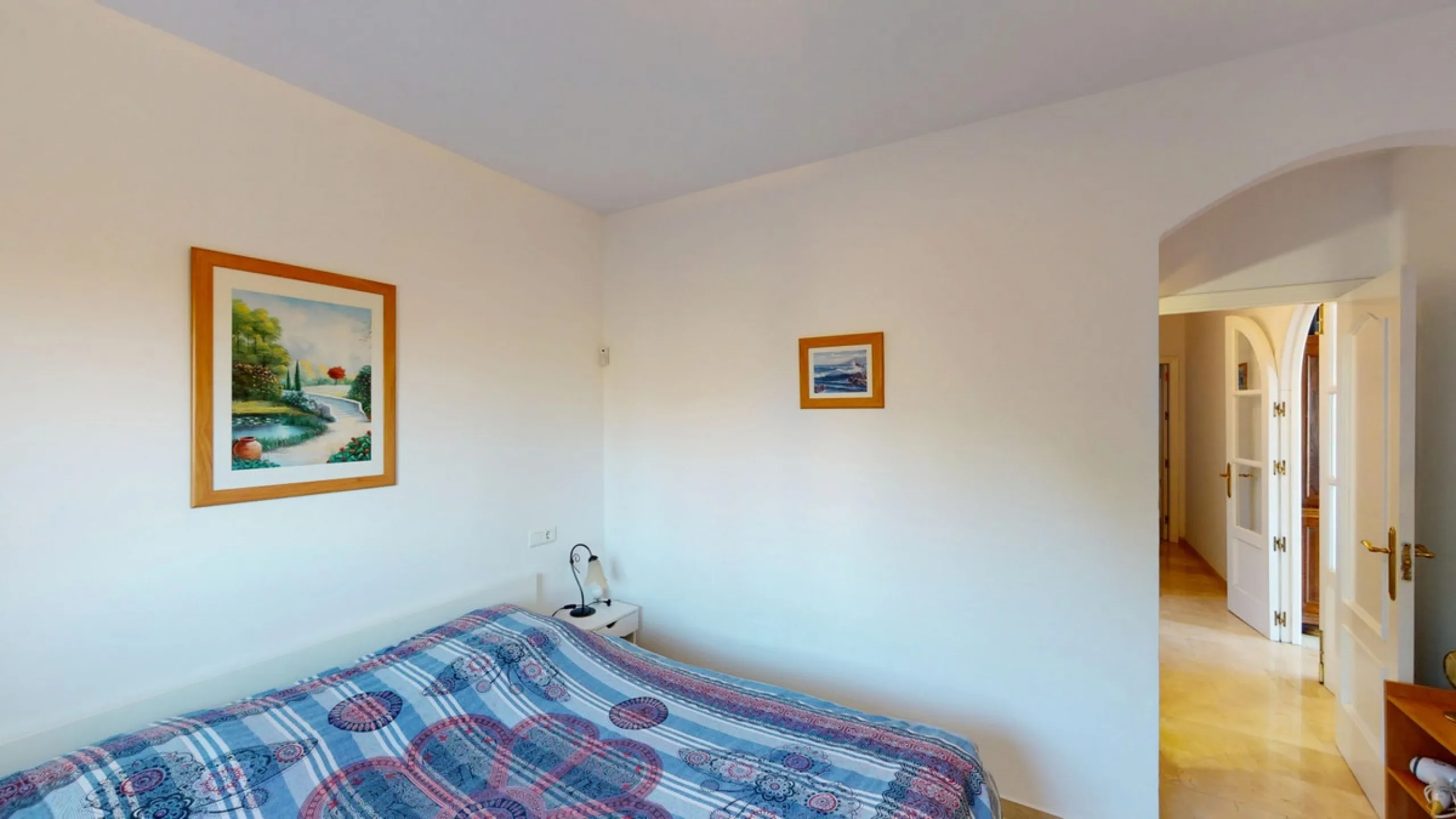 This elegant villa in Arenas, Málaga, offers a harmonious blend of space and style across two levels. The residence boasts four bedrooms and three bathrooms, with the primary bedroom providing generous personal space. The ground floor houses the main livi