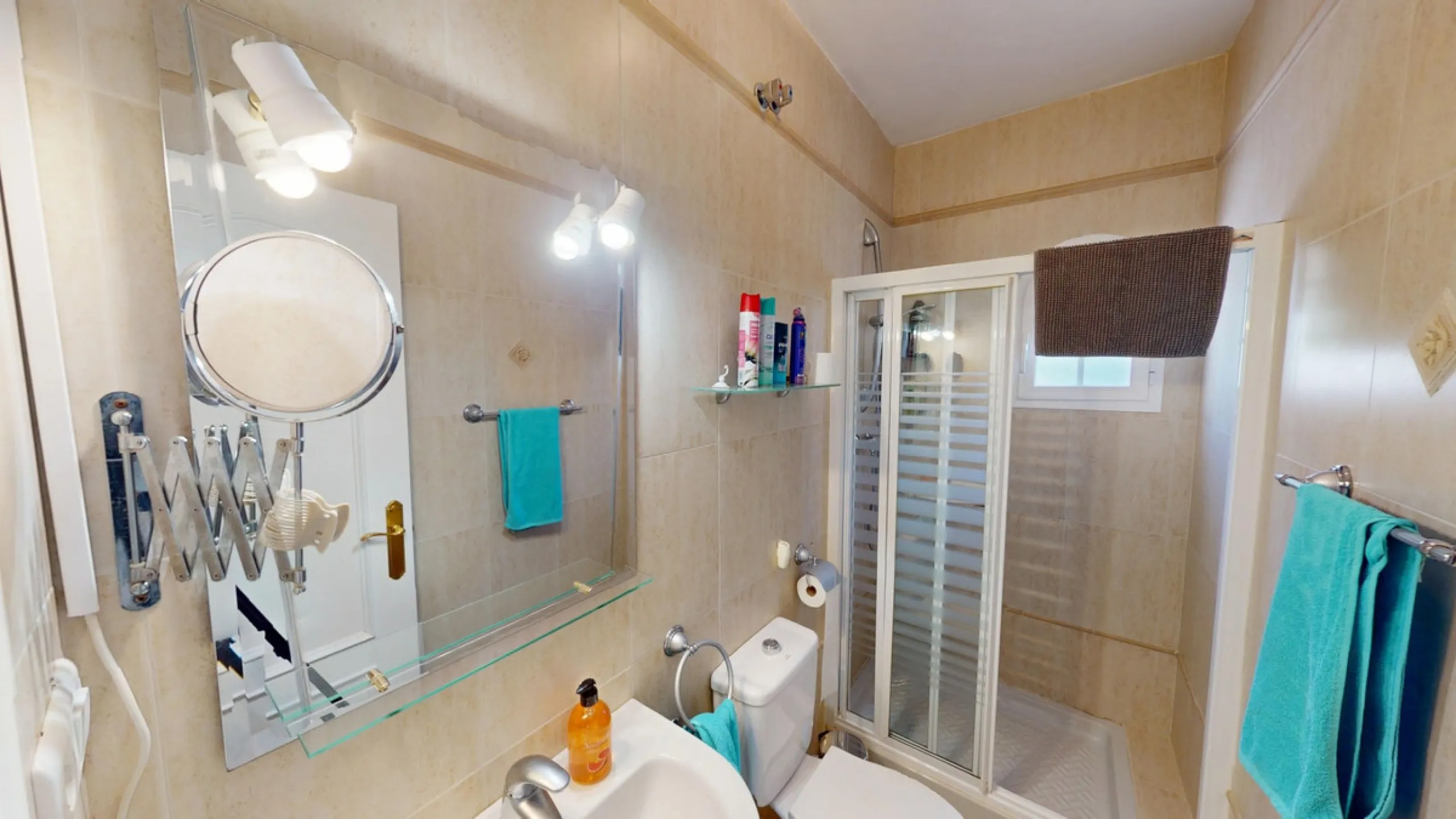 This elegant villa in Arenas, Málaga, offers a harmonious blend of space and style across two levels. The residence boasts four bedrooms and three bathrooms, with the primary bedroom providing generous personal space. The ground floor houses the main livi