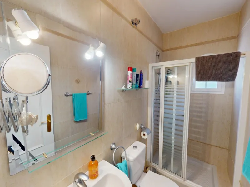 This elegant villa in Arenas, Málaga, offers a harmonious blend of space and style across two levels. The residence boasts four bedrooms and three bathrooms, with the primary bedroom providing generous personal space. The ground floor houses the main livi