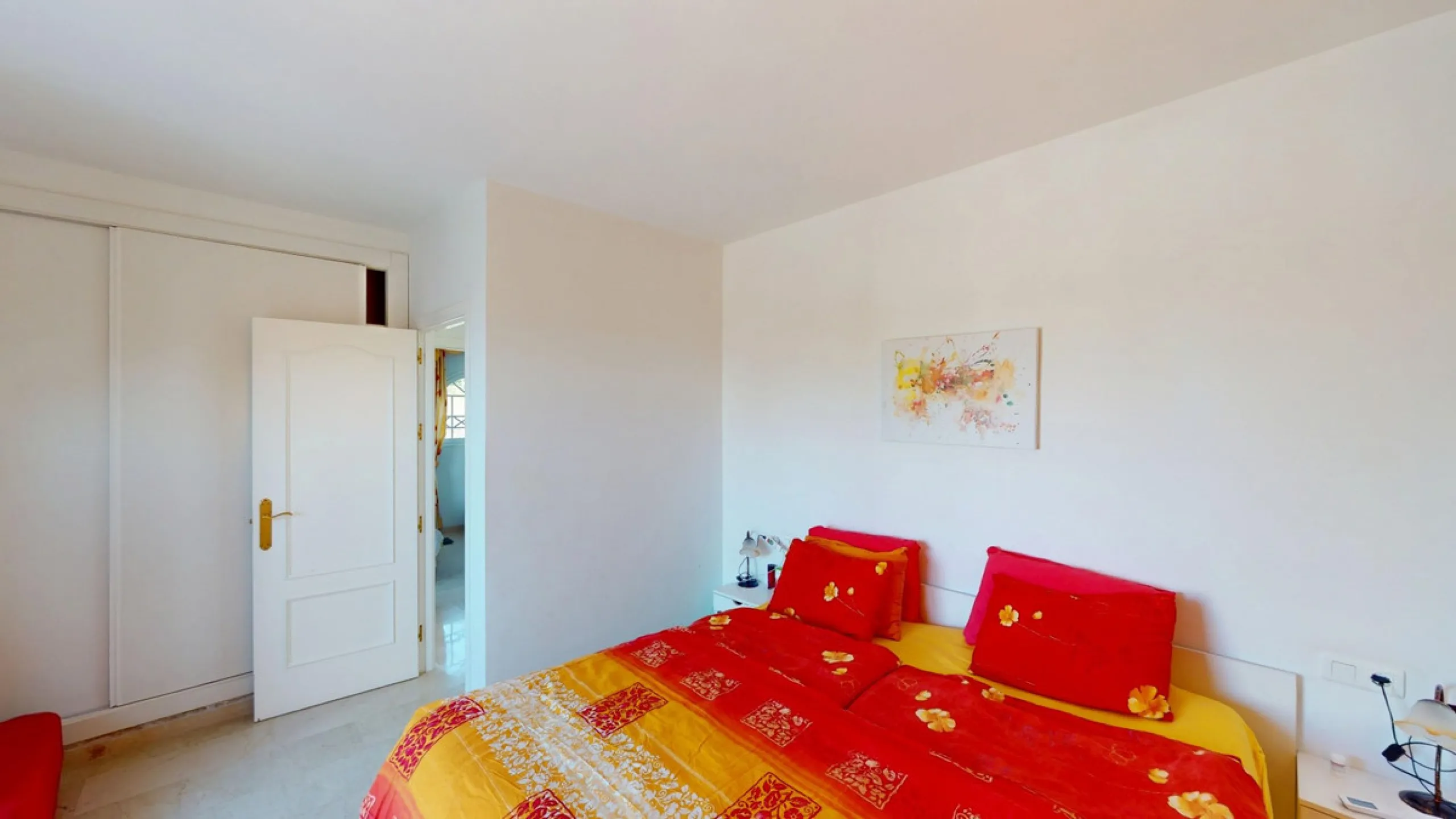 This elegant villa in Arenas, Málaga, offers a harmonious blend of space and style across two levels. The residence boasts four bedrooms and three bathrooms, with the primary bedroom providing generous personal space. The ground floor houses the main livi