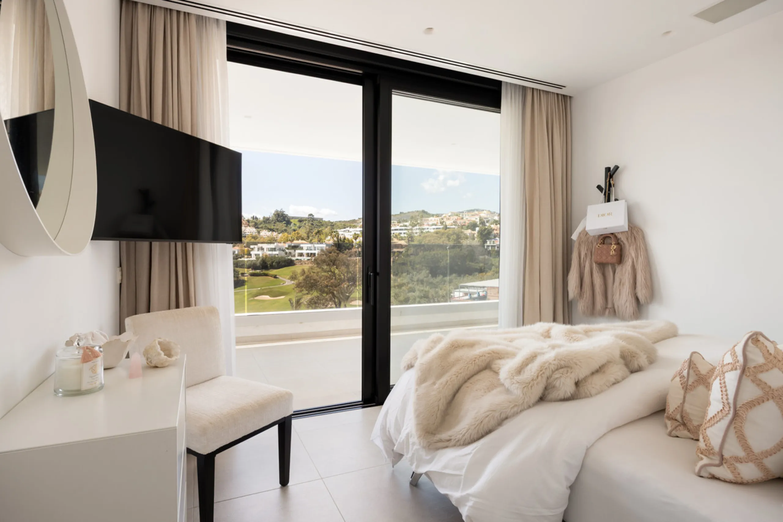 Contemporary villa set in the heart of Nueva Andalucía's prestigious Golf Valley, enjoying a privileged west-facing orientation overlooking the renowned Los Naranjos Golf Course. Distributed across three levels, the residence captures sweeping views of ma