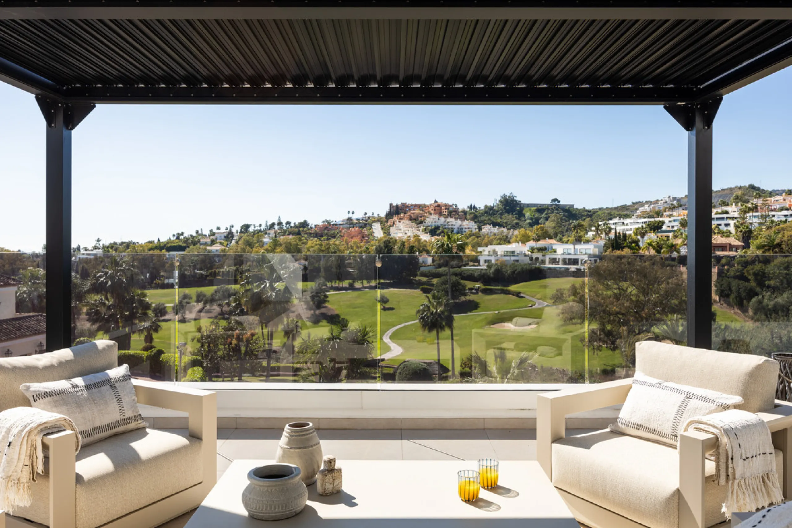 Contemporary villa set in the heart of Nueva Andalucía's prestigious Golf Valley, enjoying a privileged west-facing orientation overlooking the renowned Los Naranjos Golf Course. Distributed across three levels, the residence captures sweeping views of ma