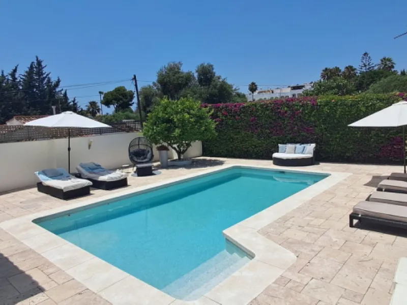 Stunning 6-bedroom, 6-bathroom detached villa located in a secure, gated community just a 10-minute walk from the beach and moments from the heart of Marbella.