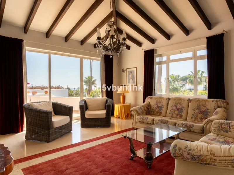 Hidden among palm trees and mature gardens in the established residential area of Sitio de Calahonda, this beautiful Andalusian villa captures the essence of traditional Mediterranean living. From the moment you arrive through the private gated entrance a