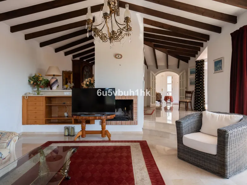 Hidden among palm trees and mature gardens in the established residential area of Sitio de Calahonda, this beautiful Andalusian villa captures the essence of traditional Mediterranean living. From the moment you arrive through the private gated entrance a