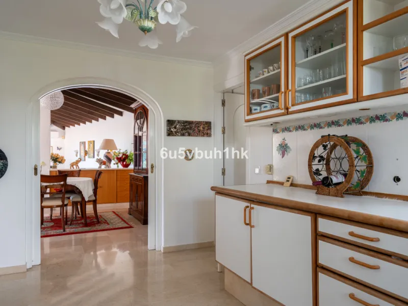 Hidden among palm trees and mature gardens in the established residential area of Sitio de Calahonda, this beautiful Andalusian villa captures the essence of traditional Mediterranean living. From the moment you arrive through the private gated entrance a