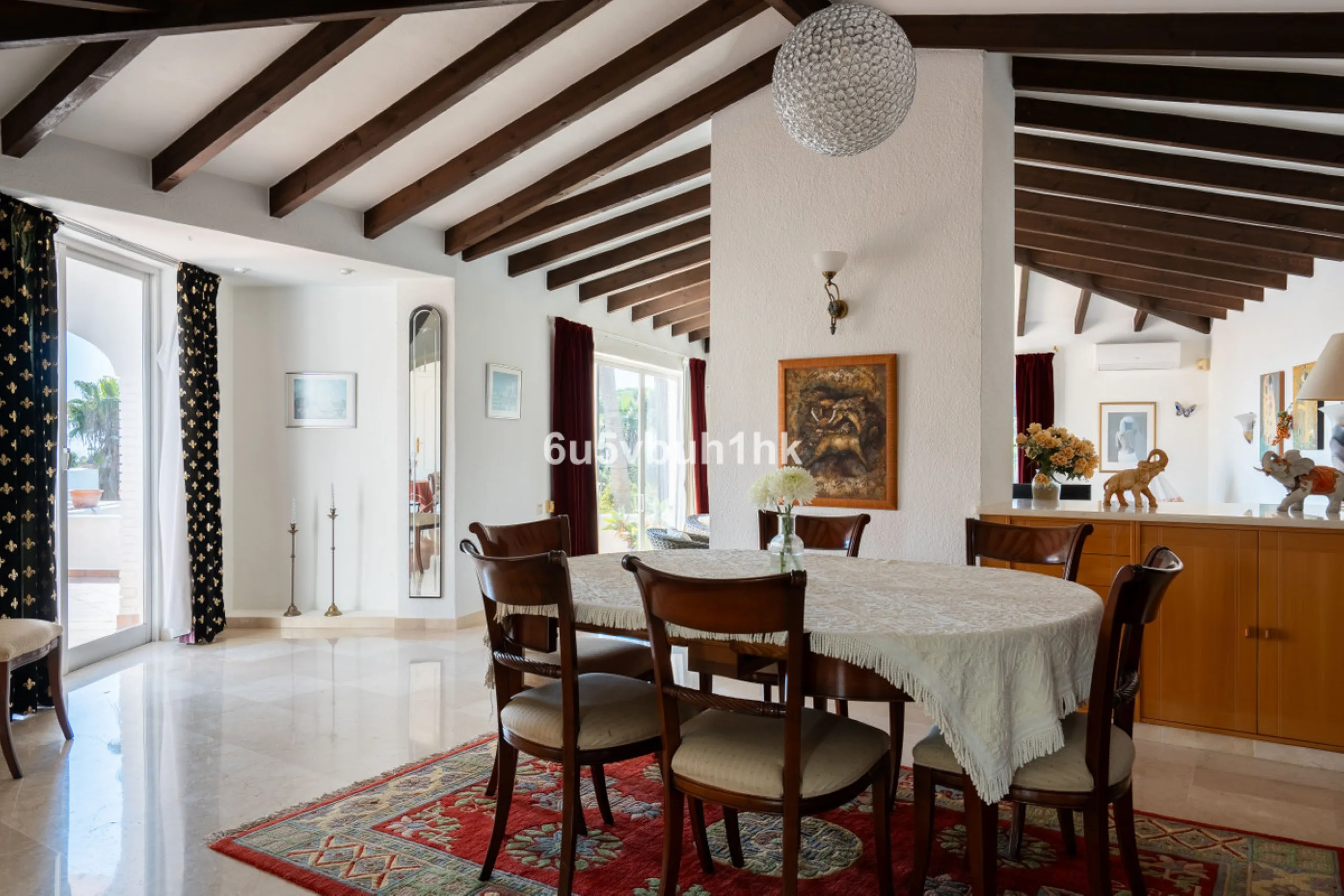 Hidden among palm trees and mature gardens in the established residential area of Sitio de Calahonda, this beautiful Andalusian villa captures the essence of traditional Mediterranean living. From the moment you arrive through the private gated entrance a